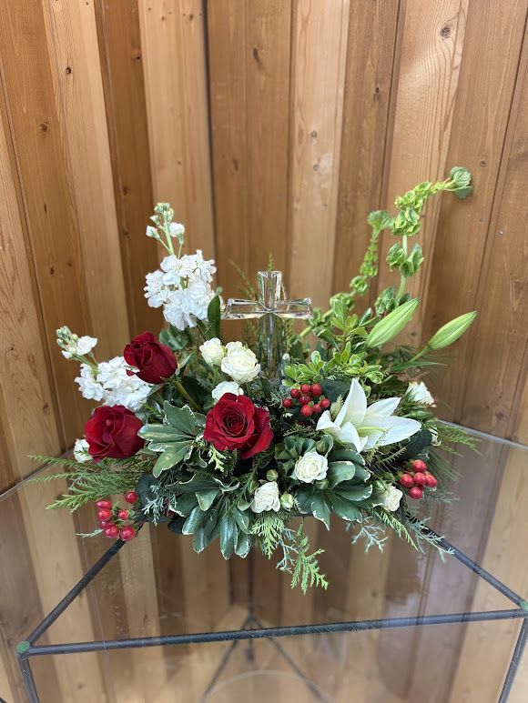 Crystal Cross of Joy - The crystal cross is nestled elegantly among red and white blooms, this keepsake brings joy and light to your special occasion. Red roses, white spray roses, red miniature carnations, white cushion spray chrysanthemums are adorned with white limonium, varigated pittosporum, noble fir, and cedar. Delivered with Teleflora's Crystal Cross Keepsake. Orientation: One-Sided
