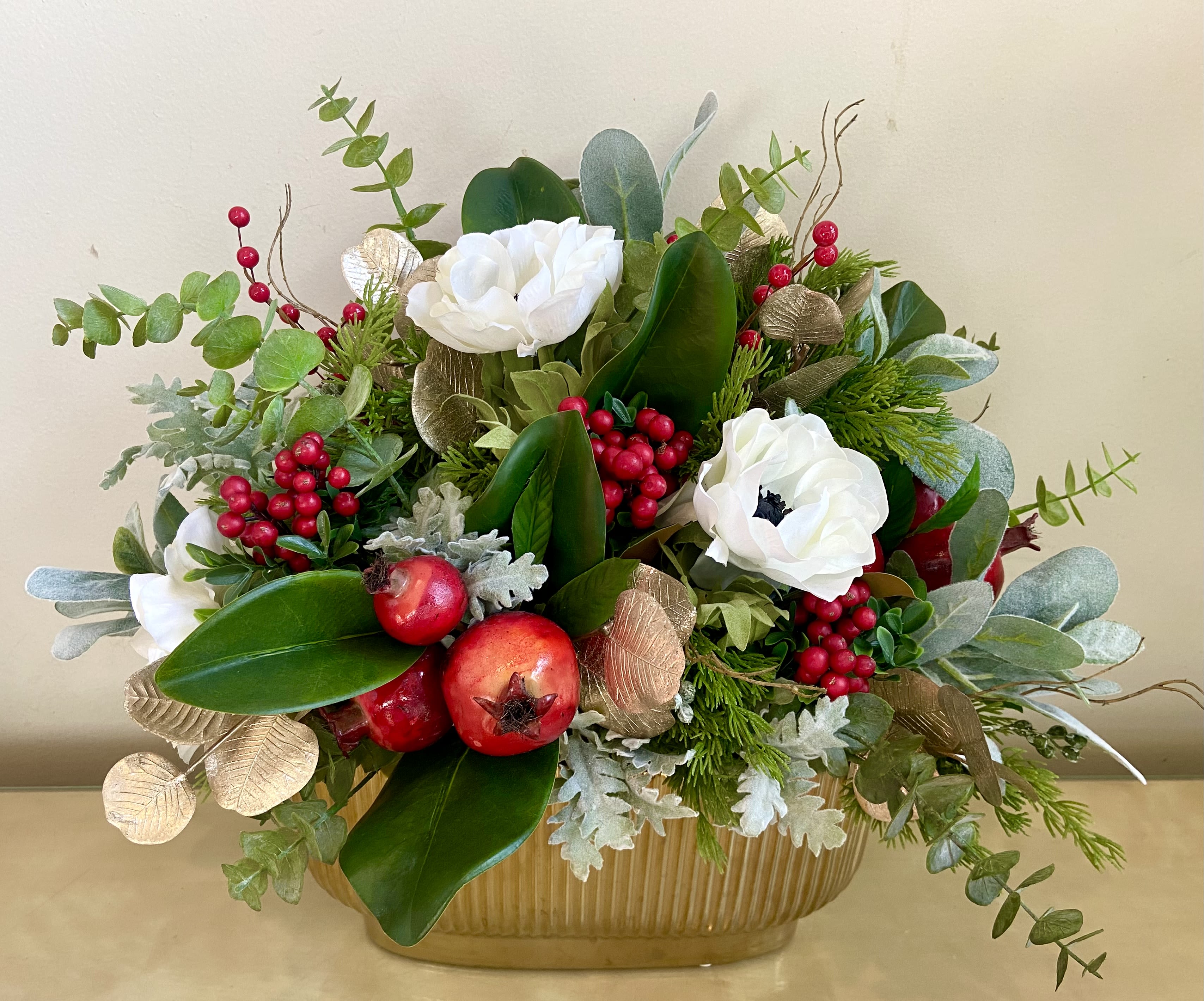 Holiday Silk Surprise - Surprise!  Looks so fresh but this stunning silk centerpiece will last forever.  Lush combination of winter greens, berries, anemones, dusty miller, magnolia &amp; more in a low ceramic container.  Terrific gift or home decor.  18” high &amp; 20” long. 