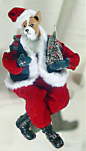 Jingle Rock Dog - Please call to verify we have your breed. This whimsical Santa Dog is run by two AA batteries stored safely in his back pack. A clap of your hands starts him jingling and jiving to the tune of "Jingle Bells." He sits easily on your table or mantle. With his lighted tree and his dancing ways he is sure to bring a smile to your face! (10" long, seated 6 1/2" high)   Available in your breed!  