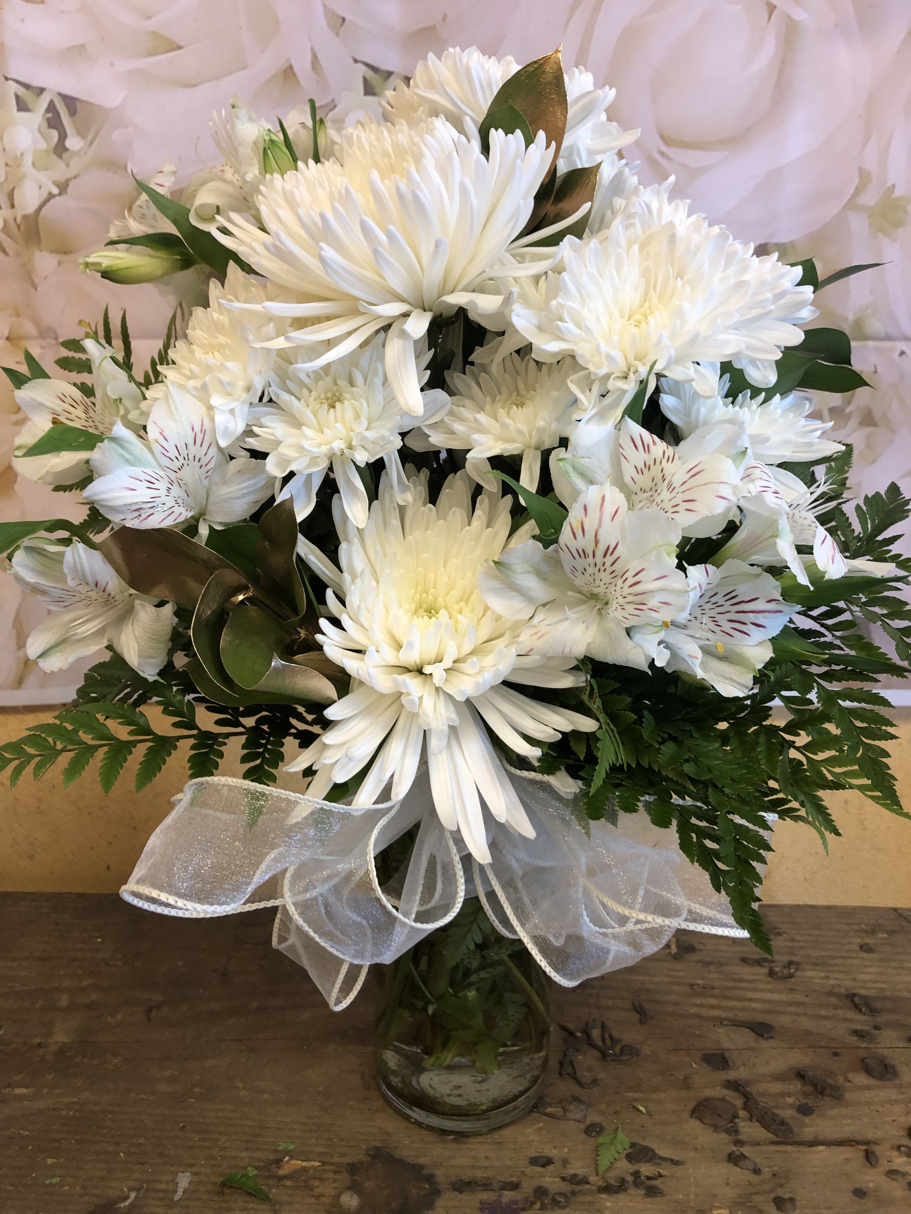 All White Vase (Designer Choice Vase Arrangement)  - NOTE: NO ROSES ADDED!  THIS ARRANGEMENT IS ABOUT 12 INCHES TALL, ITS DESINGER CHOICE WE WILL ADD ONLY WHITE FLOWERS SUCH AS CARNATIONS,  ALSTROMERIA, CUSHION, OR SPIDERS.  WE WILL ADD FILLERS SUCH AS GOLD RUSCUS AND BABY BREATH.  STANDARD SIZE IS IN THE PICTURE DELUXE AND PREMIUM IS A BIGGER VASE AND WE ADD MORE OF THE SAME FLOWERS.  AGAIN NO ROSES ARE INCLUDED IN ANY OF THE UPGRADES. 