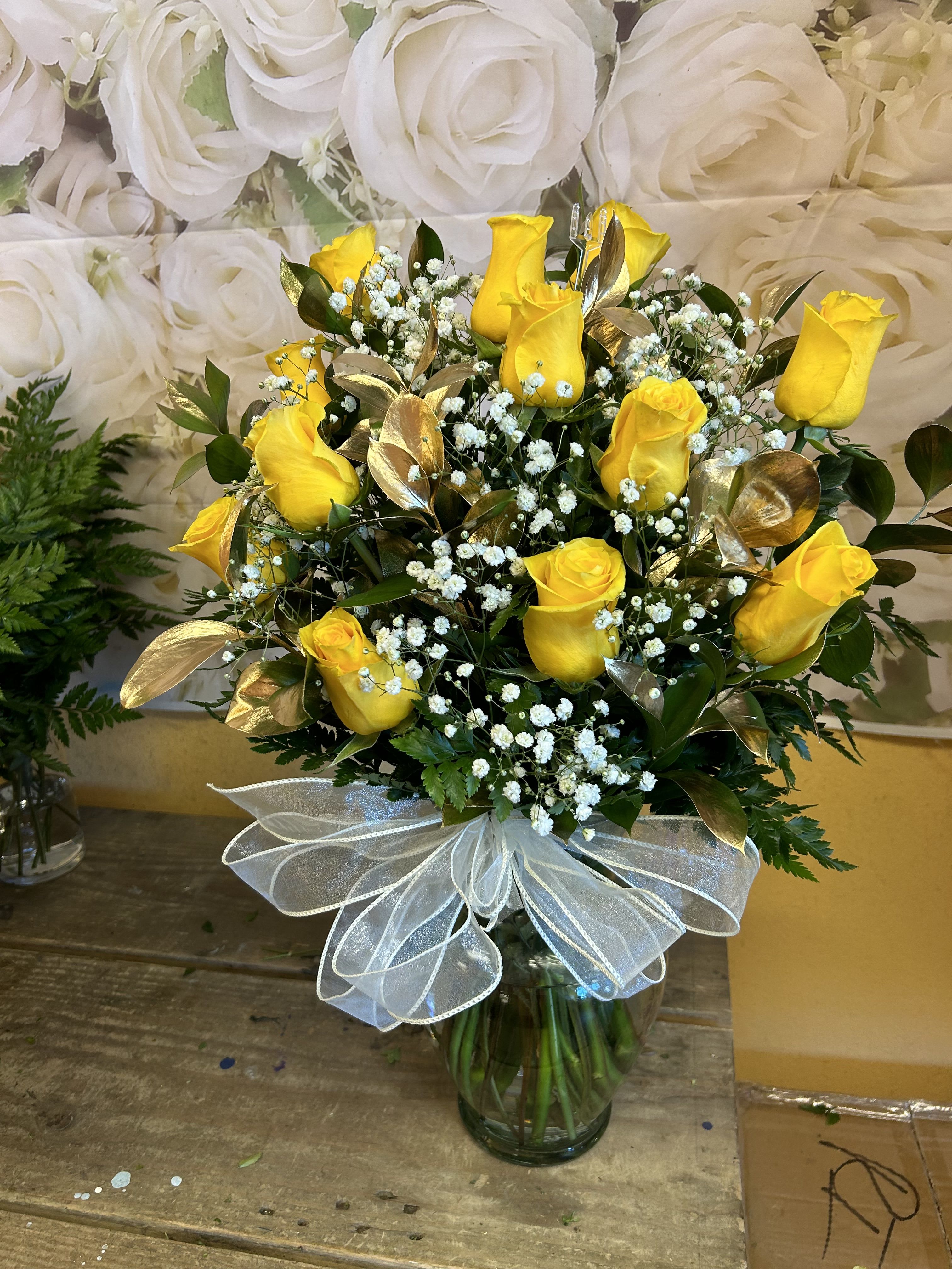 12 YELLOW ROSES IN A VASE - 12 YELLOW ROSES IN A VASE WITH BABY BREATH AND GOLD RUSCUS.   STANDARD SIZE INCLUDES 12 ROSES DELUXE SIZE INCLUDES 18 ROSES PREMIUM SIZE INCLUDES 24 ROSES