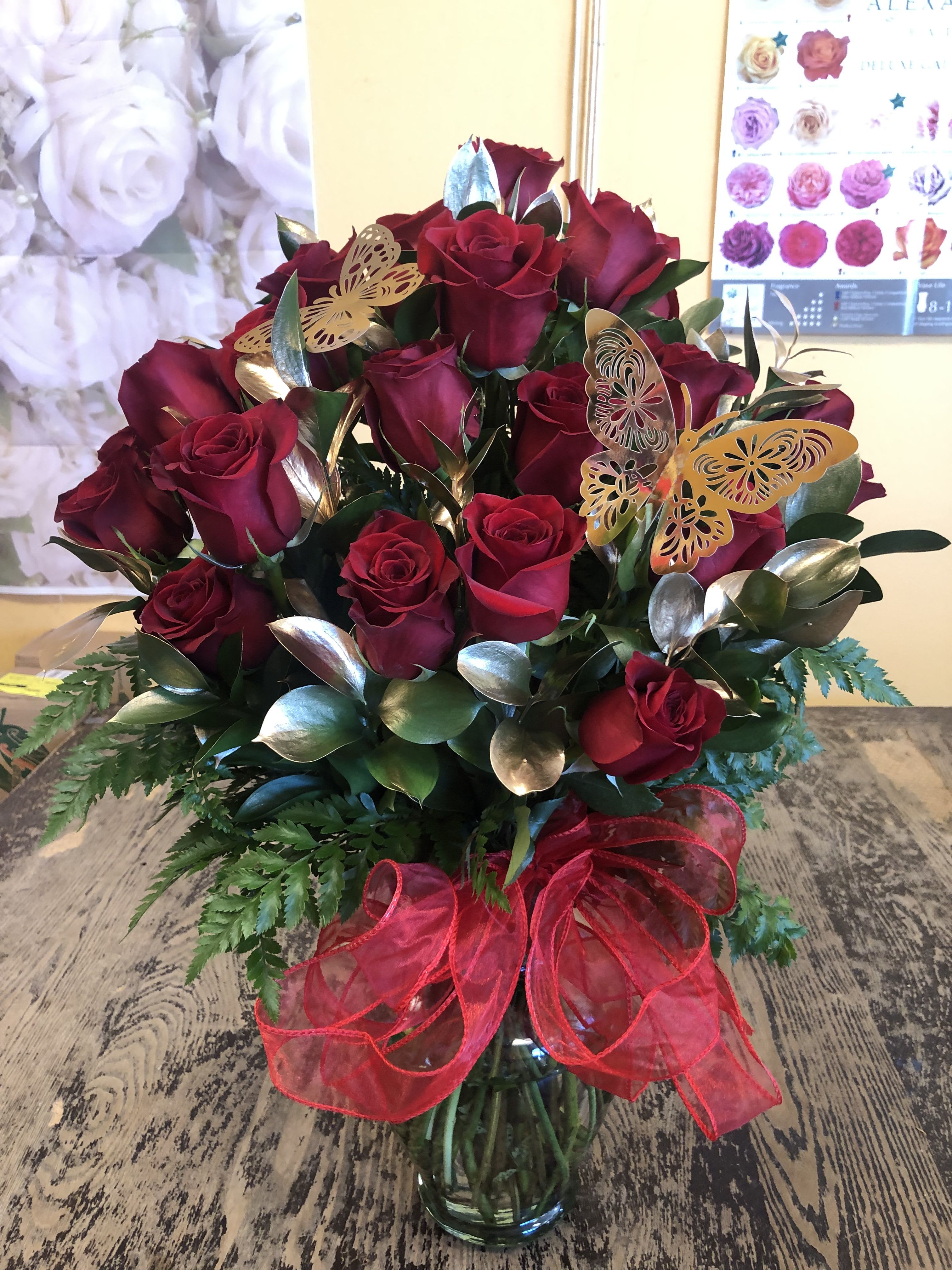 GOLD LOVE - 24 RED ROSES WITH GOLD RUSCUS ALL AROUND IN A VASE WITH A RED BOW.  VERY ELEGANT FOR ANY OCCASSION. 