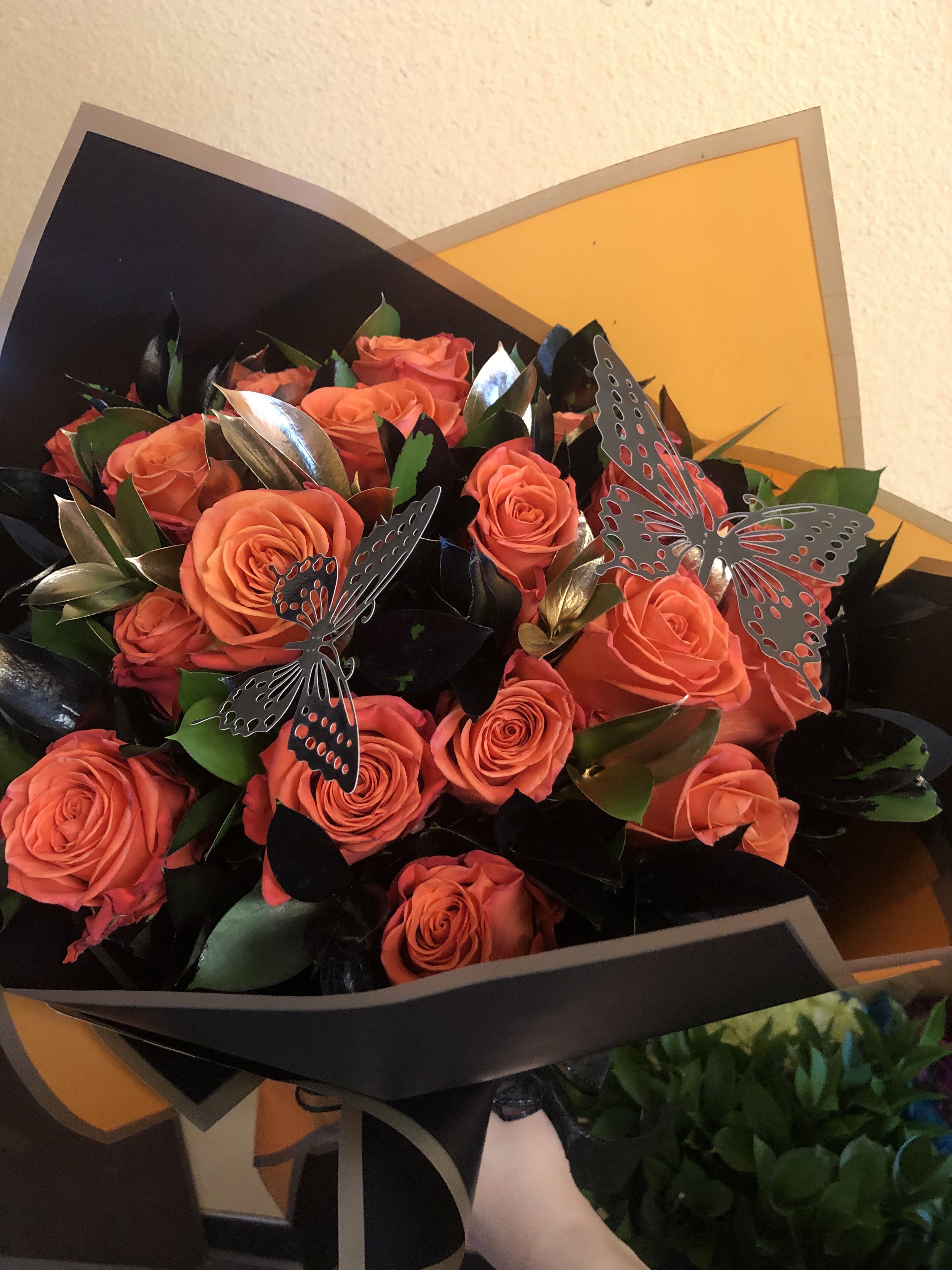 HALLOWEEN ORANGE ROSES  - 12 ORANGE ROSES WITH BLACK AND GOLD RUSCUS WITH BLACK BUTTERFLIES ALL WRAPPED IN BLACK AND ORANGE KOREAN PAPER STANDER SIZE IS 12 ROSES DELUXE SIZE IS 18 ROSES PREMIUM SIZE IS 24 ROSES
