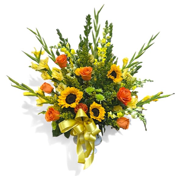 Vibrant Life Footed Urn - This vibrant sympathy arrangement is thoughtfully designed in a 6-inch container, with a lush combination of foliage, including myrtle, jade, and variegated greens, creating a rich, organic backdrop for the bright blooms. Three cheerful sunflowers bring warmth and a sense of hope, while six elegant yellow gladioli stand tall, symbolizing strength and integrity. The four yellow snapdragons add a touch of grace, complemented by seven stunning orange roses that express admiration and happiness. Accenting this lively bouquet are four stems of sunny yellow button poms and five stems of golden solidago, bringing further brightness. Together, these flowers create a heartfelt tribute, celebrating life and offering comfort during times of sorrow.