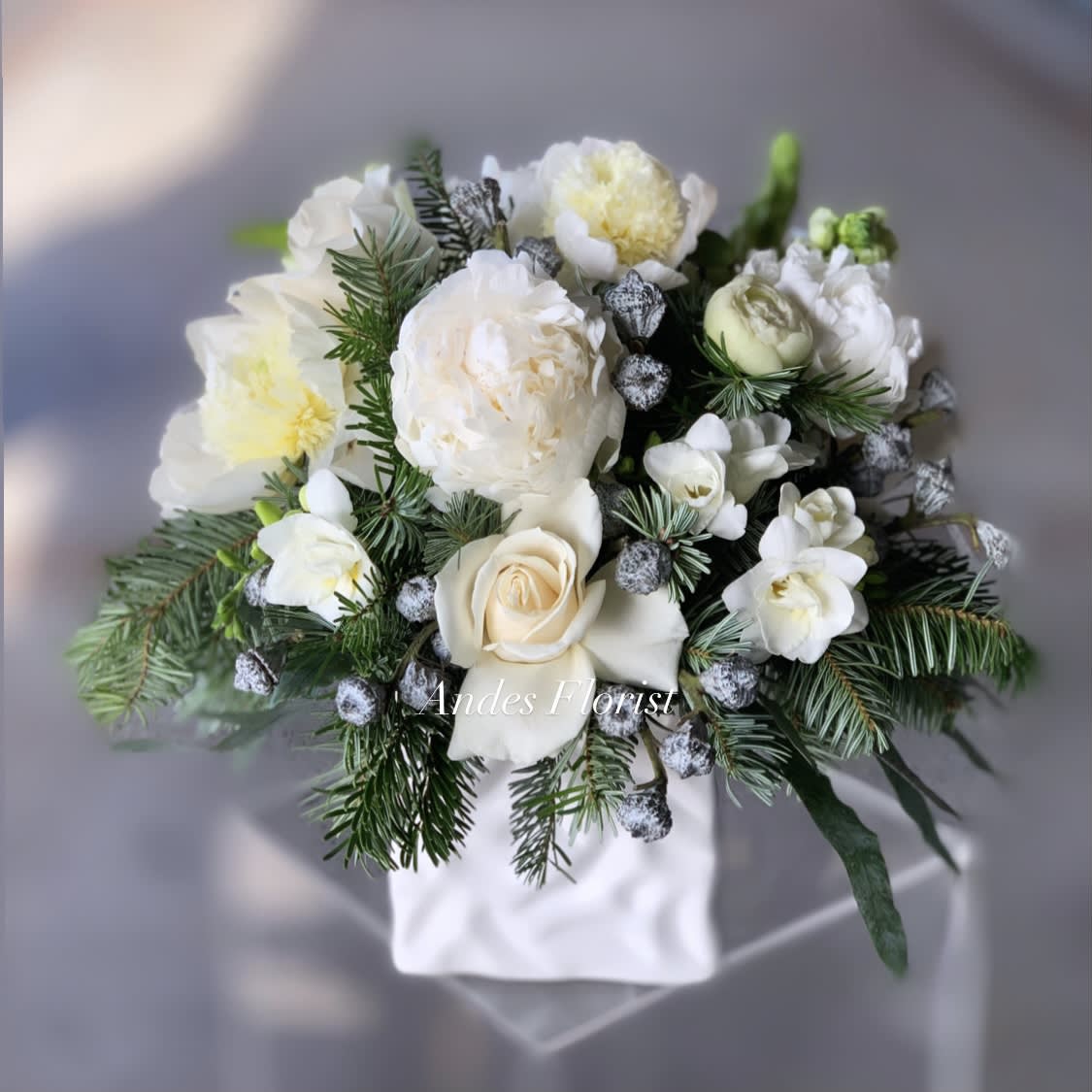 Prancer - Winter Wonderland Inspired Holiday Flowers - Peonies, Freesias, Roses and Star of Bethlehem make for this chilly winter wonderland inspired design in a silver vase. Brrr! It's feeling like the holidays! 