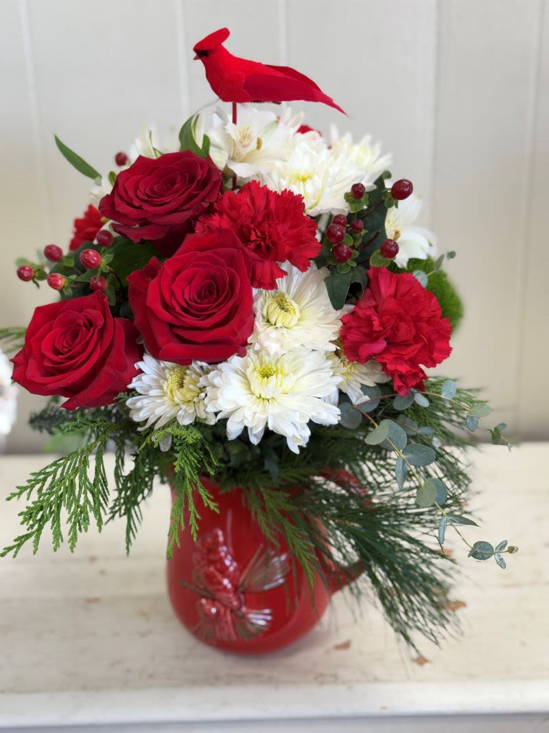 Scarlet Cardinal Bouquet Pitcher - This Scarlet Cardinal Bouquet celebrates the season with festive red blooms and winter greens in a keepsake Scarlet Cardinal Pitcher. A heartfelt gift for Christmas or anyone who cherishes holiday tradition. This festive  Holiday Centerpiece will be a joyous addition to your home.  It's the perfect gift to add to any celebration.  