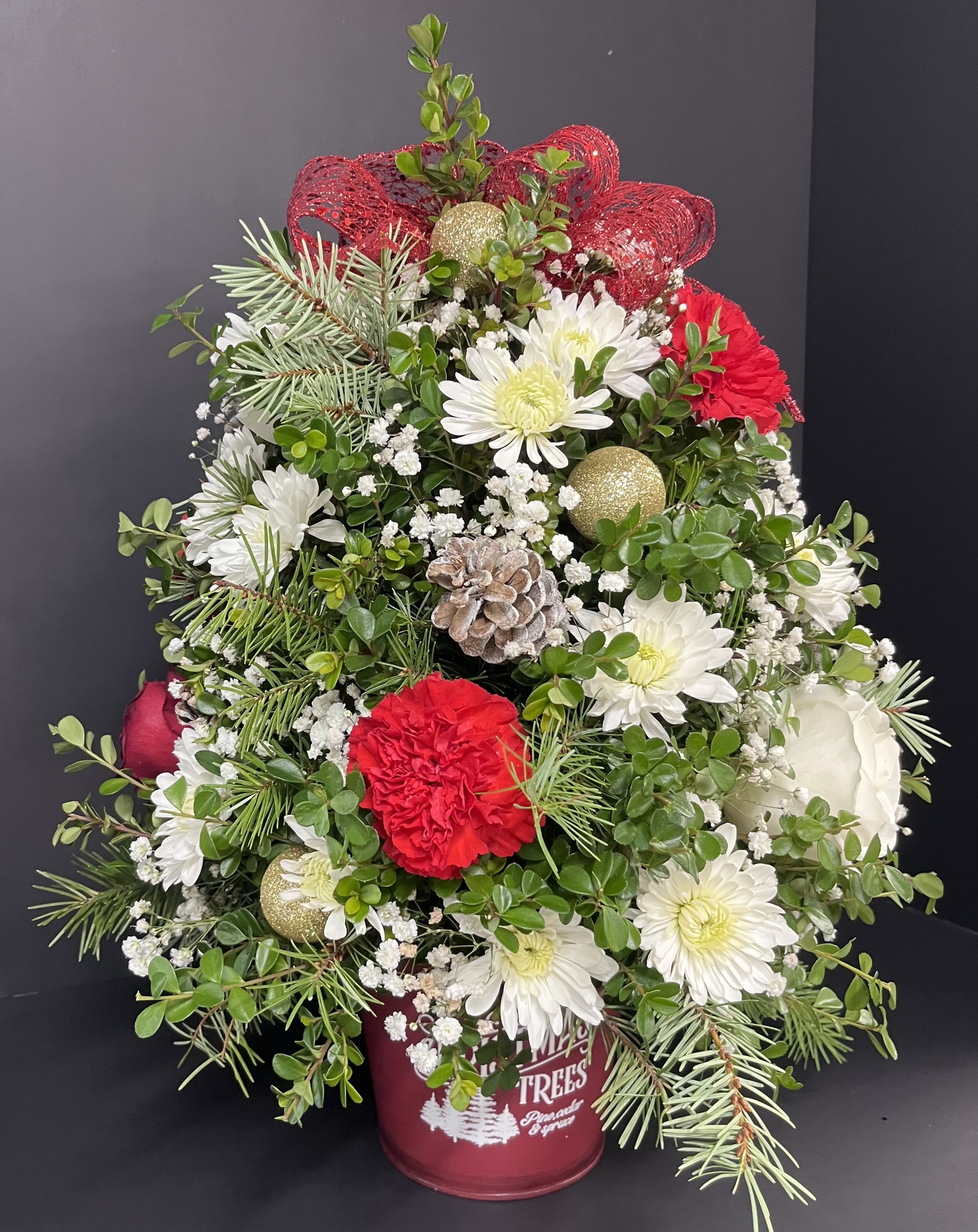 Santa Flowering Tree - Our flowering  tree is designed by hand,  with bright blooms and embellished with christmas balls for the merry season.  Each tree is unique with different embellishments of christmas balls and pine cones.  The big christmas themed  bow on the top may vary.