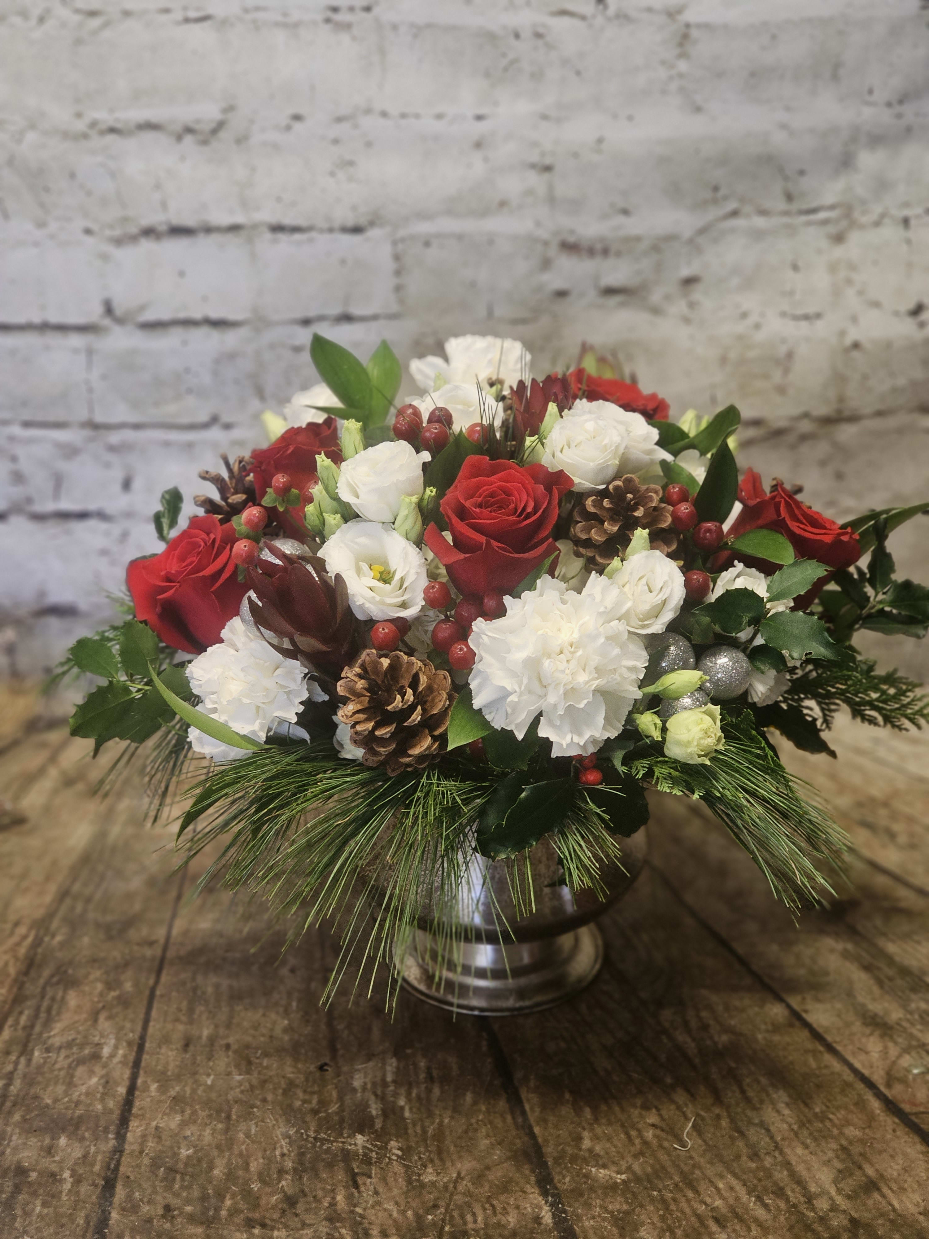 Crimson Frost  - A beautiful centerpiece in a silver pedestal featuring a lovely assortment of Christmas flowers