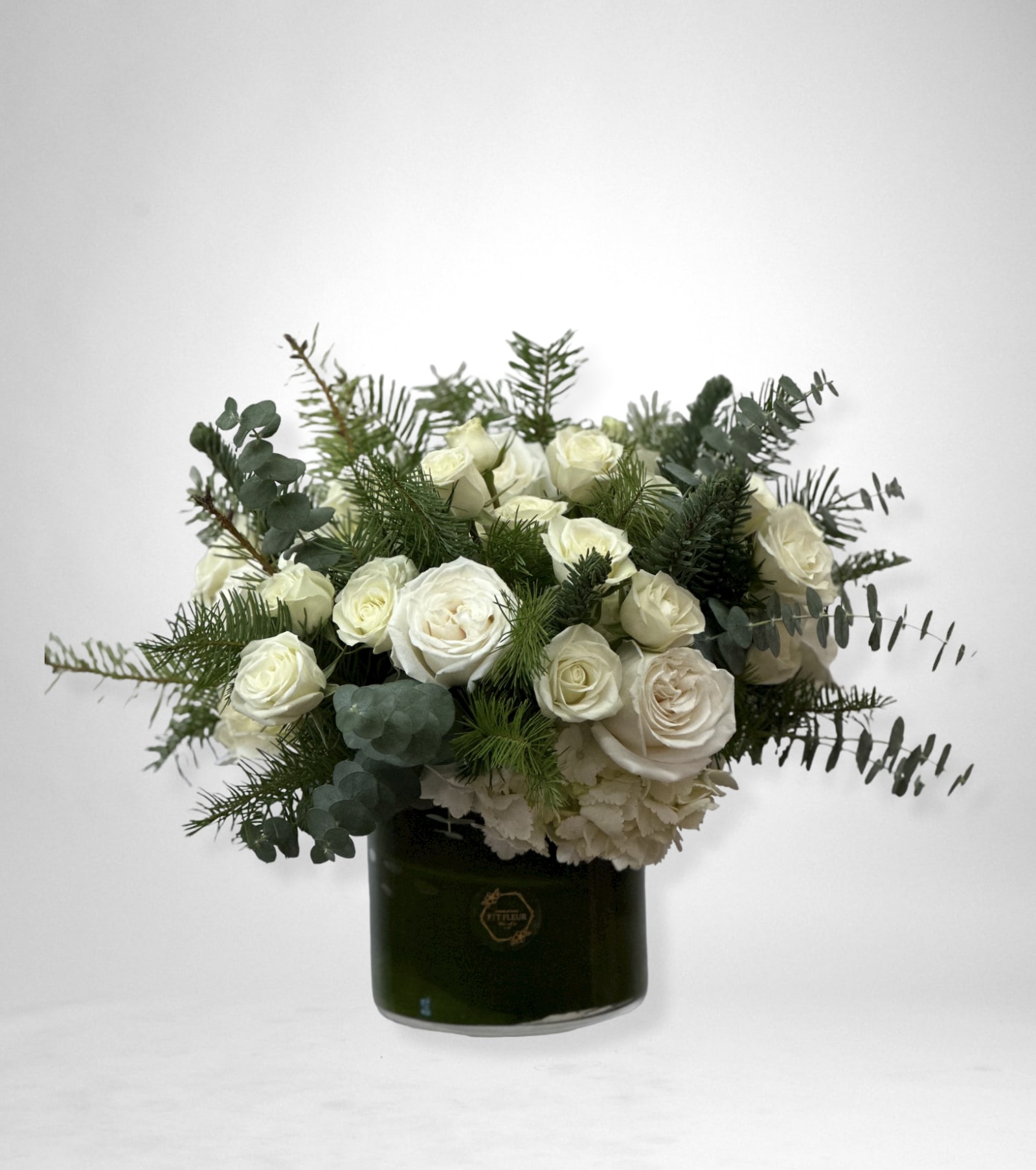 Jenara - This arrangement comes in a glass round vase, with roses, hydrangea and greenery. 
