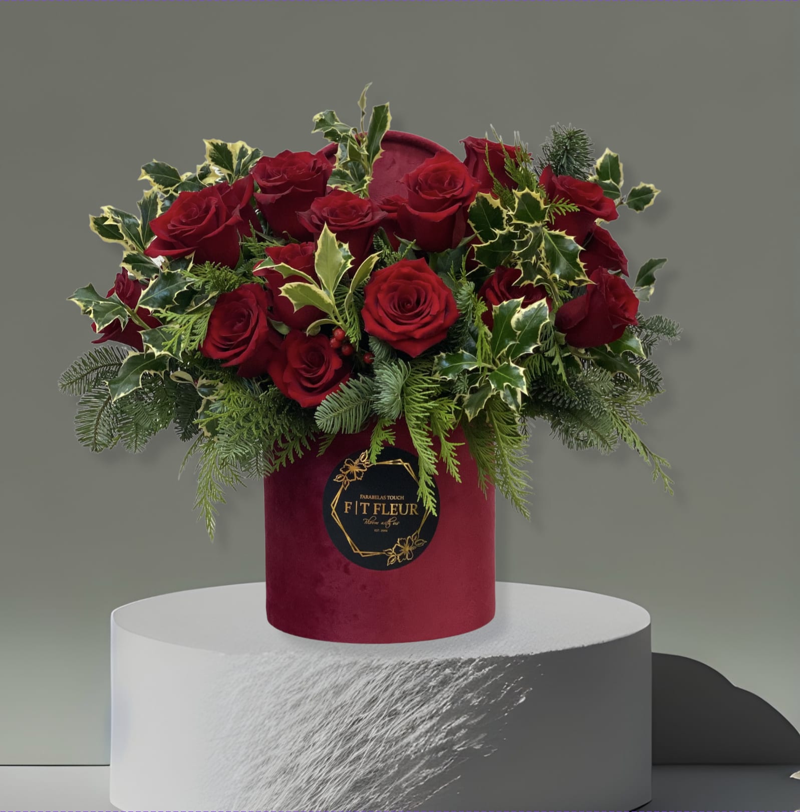 Holly - This arrangement comes in a Hat box with beautiful red roses and holiday greenery. 