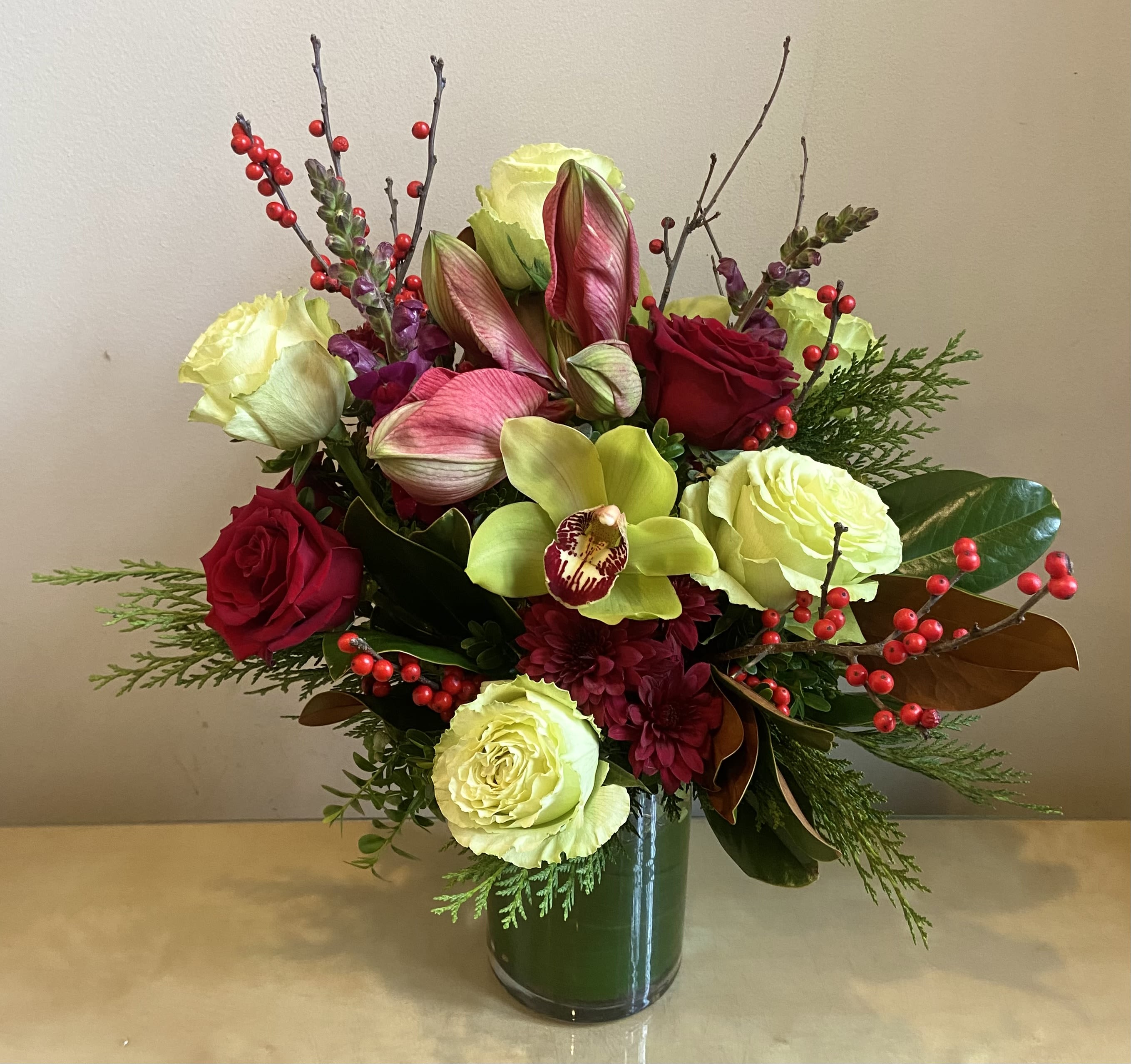 Merry &amp; Bright - Festive and bright holiday arrangement with amaryllis, roses, cymbidium orchids, ilex berries &amp; more. 18” tall.