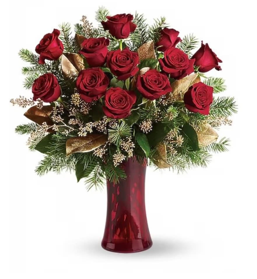Christmas Dozen roses - Dazzling and delightful. A dozen red roses make a dashing holiday gift, especially when they are arranged with brilliant holiday touches and delivered in a ruby red vase. Twelve beautiful rose blossoms mix with salal, eucalyptus and golden fir branches in a radiantly red glass vase.