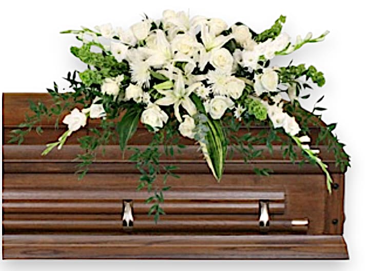 Hushed Goodbye Casket Spray - This elegant sympathy arrangement exudes a serene beauty, thoughtfully composed to express love and reverence during a time of loss. At its core, six towering white gladiolus create a striking focal point, symbolizing strength and moral integrity. Surrounding them are three graceful white lilies, which impart a sense of purity and tranquility. The arrangement is further enriched by twelve pristine white roses, each embodying profound love and remembrance. Delicate white spider mums and two stems of white cushion Poms add texture and softness, enhancing the overall gracefulness of the display. Completing this sophisticated ensemble, six Bells of Ireland rise gently amid the blooms, representing hope and peace. Set against a lush backdrop of aspidistra leaves and ruscus foliage, this arrangement conveys an enduring message of sympathy and support, honoring the memory of a loved one with its timeless elegance.