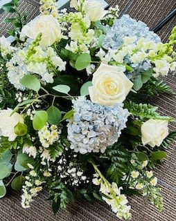 Blue and white centerpiece - Rounded bouquet - you pick colors.  Can be placed alone or atop a riser.  There are several options including pilsner, cylinders, hourglass, and ornate metal vintage stands.