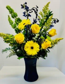 Bright side - Yellow gerbers, yellow roses, solidago and blue delphinium combined in a blue gathering vase