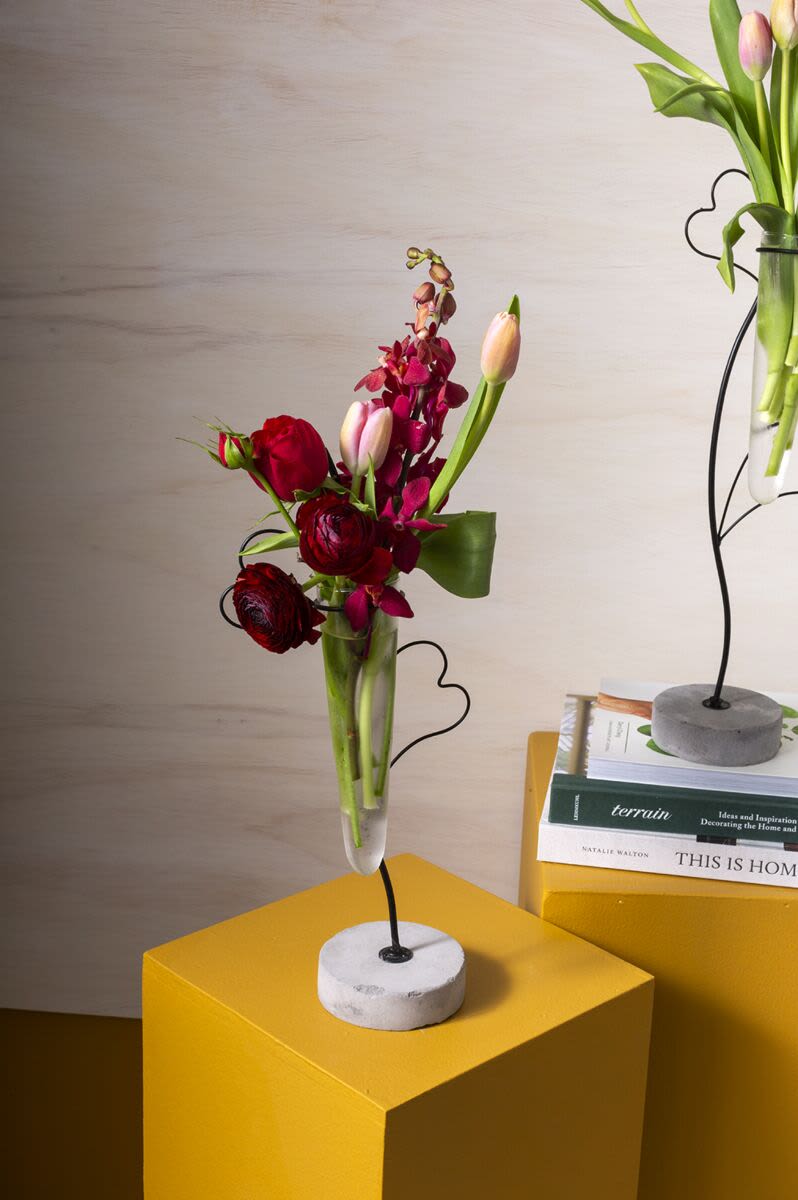 Florette – Modern Red &amp; Pink Floral Arrangement - A chic, modern floral arrangement featuring seasonal blooms in red and pink tones, designed with clean lines and airy movement. Styled in a clear glass vase elevated on a sculptural black metal stand for a contemporary, artistic look.  Perfect for birthdays, anniversaries, thank-you gestures, or stylish everyday gifting. Flower varieties and shades may vary slightly based on availability while maintaining the overall modern aesthetic, balance, and value.