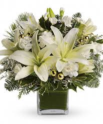 Snow White Holidays - Embrace the beauty of a pristine winter wonderland with our Snow White Holidays arrangement. This elegant all-white design features a stunning selection of snowy blooms—think delicate roses, lush hydrangeas, and fragrant lilies—perfectly complemented by fresh winter greenery and festive accents.  Whether adorning your holiday table or gifted to someone special, this arrangement captures the serene magic of the season with timeless style and grace.