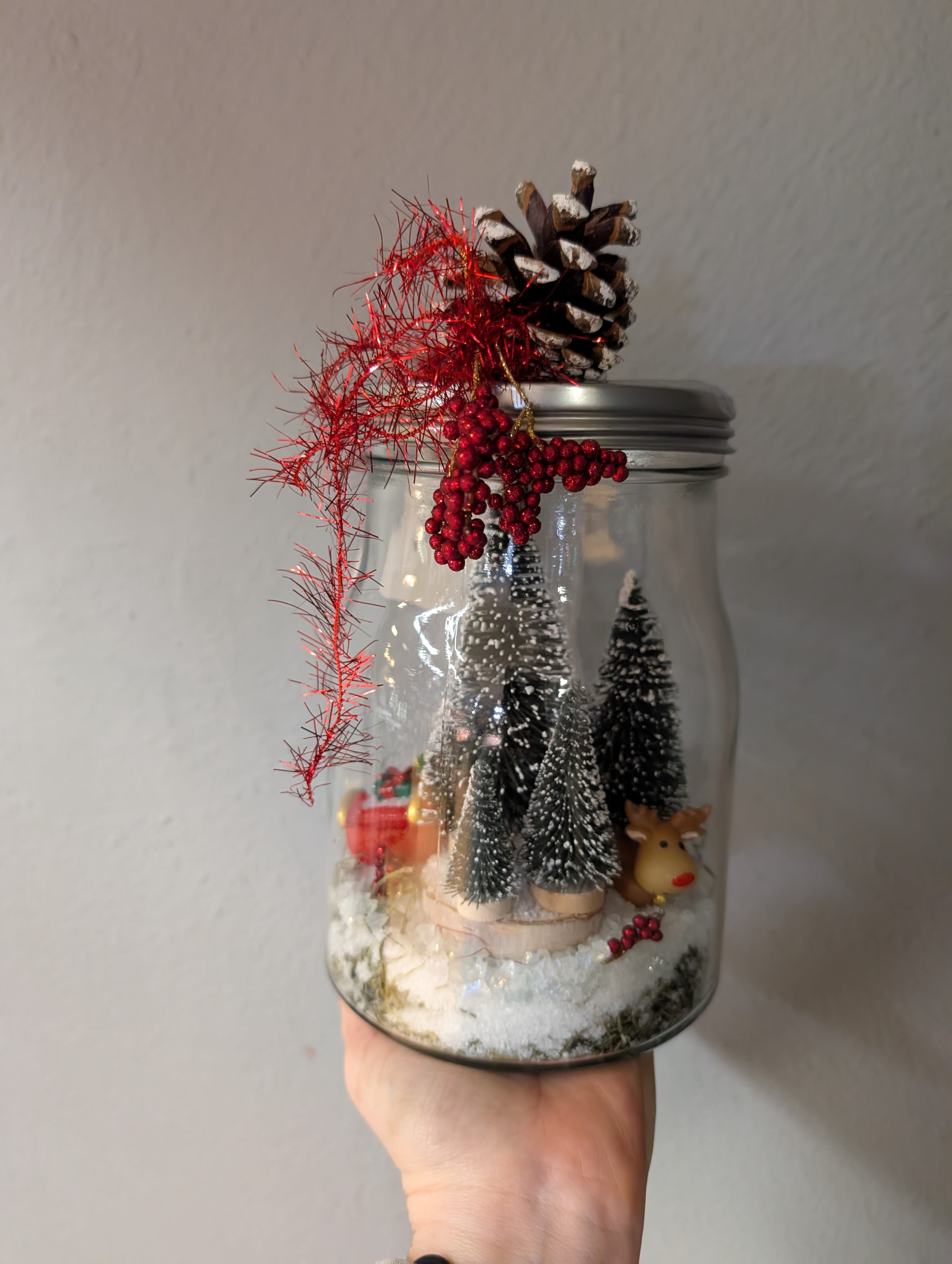 Pk Holiday Decor resting Rudolph - This adorable vintage mason jar has captured Rudolph the Red-Nosed Reindeer amongst the Evergreens taking a break with his sleigh full of gifts. This cute home decor item is perfect for your holiday festivities.