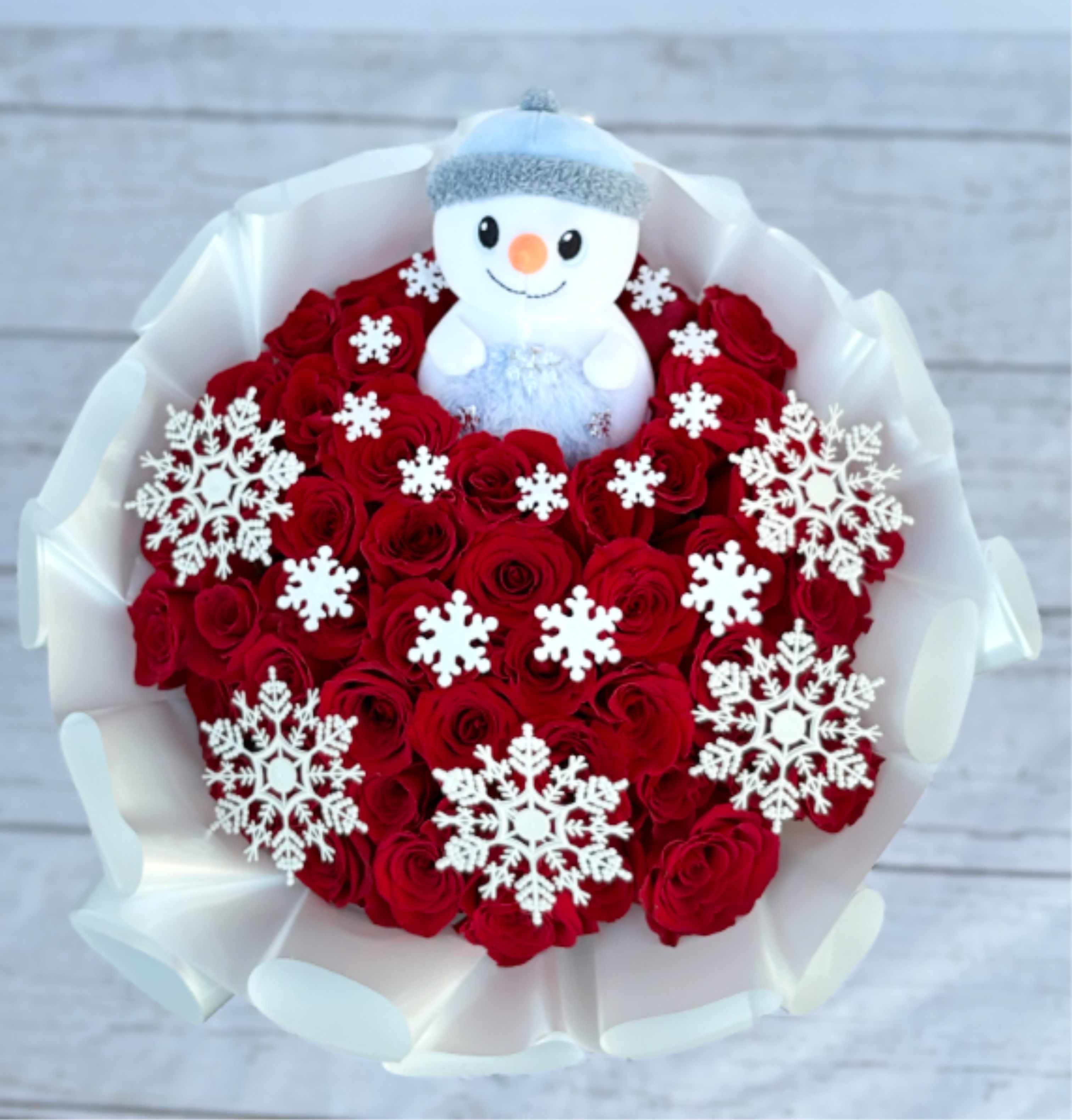 Snow man Magic Spirit Maxi Bouquet - 48 long stem roses, white wrapping paper, snowflakes, and a snowman enjoy
