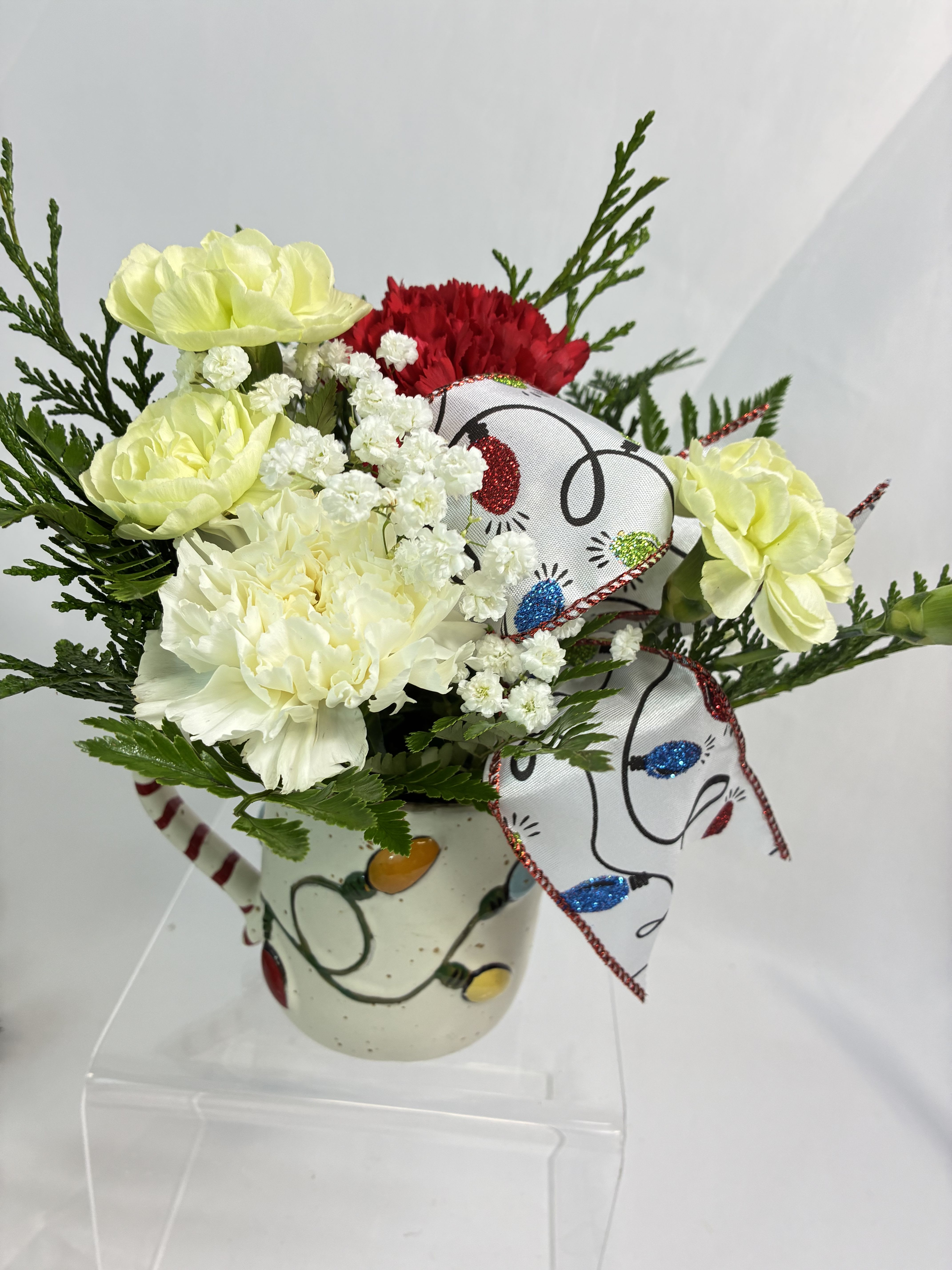 Twinkling Lights Bouquet - Turn on the twinkling lights with this fun fresh arrangement in a Mud Pie brand, Farmhouse Christmas mug! With Christmas Chrysanthemums, fresh Cedar with all the Christmas scent, and Christmas lights on this keepsake mug and accent ribbon. Send thoughts, love &amp; twinkles with this bright bouquet! 