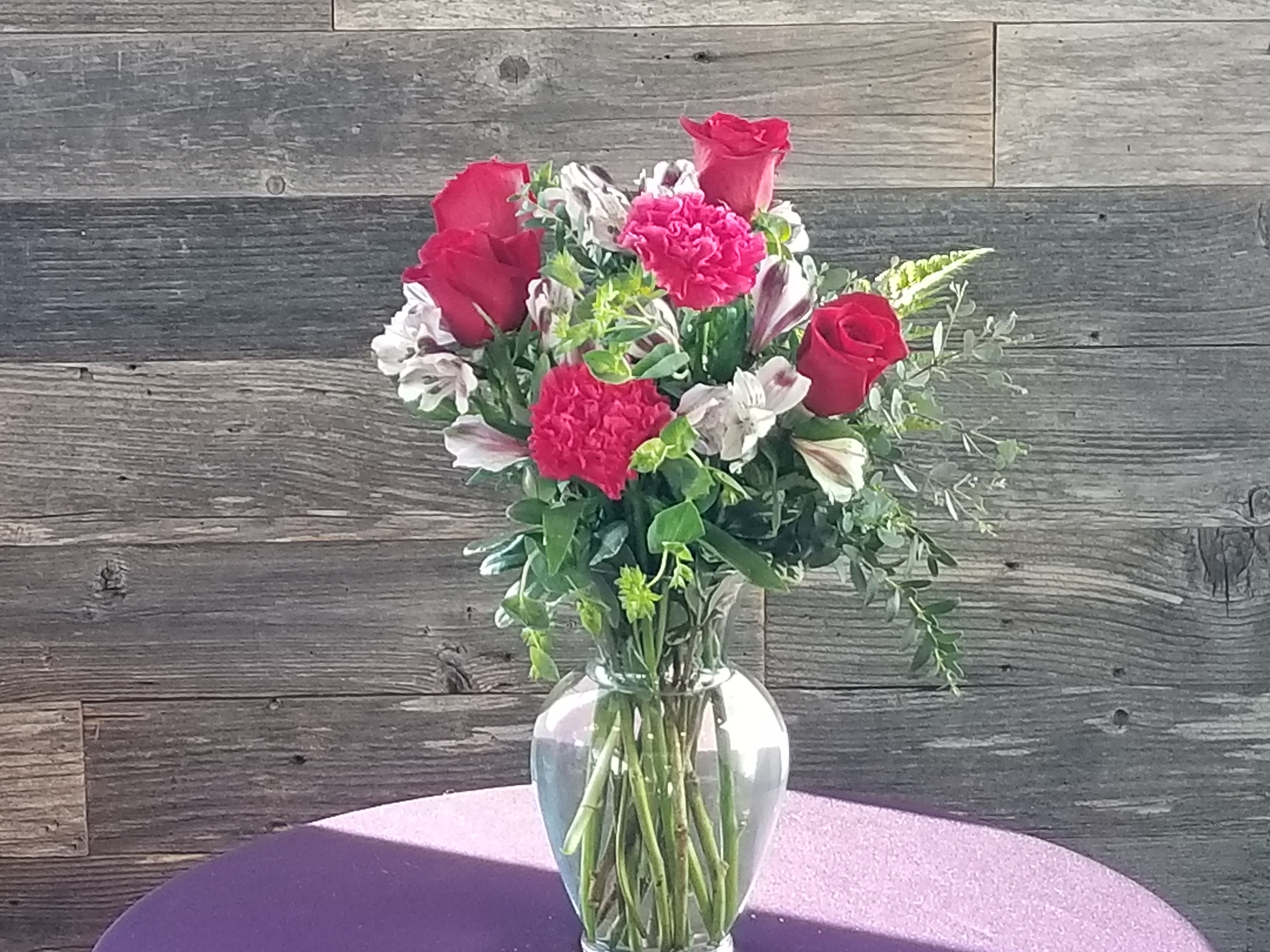 Roses and More -   Roses, alstroemeria, and carnations  with trendy greenery.    We will use seasonal colors.  This is a great mix of flowers for any occasion