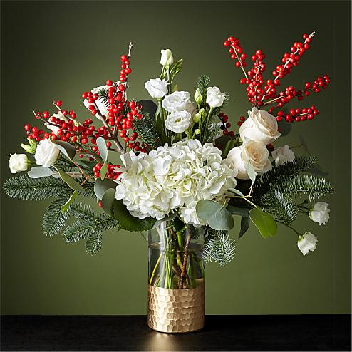 WINTER FOREST BOUQUET - String boughs of holly throughout your home with our Winter Forest Bouquet. Anticipate dynamic movement with a diverse gathering of white roses, hydrangea, lisianthus, crimson ilex berries and wooded greenery for a dazzling holiday.  Please Note: The bouquet pictured reflects our original design for this product. While we always try to follow the color palette, we may replace stems to deliver the freshest bouquet possible, and we may sometimes need to use a different vase.
