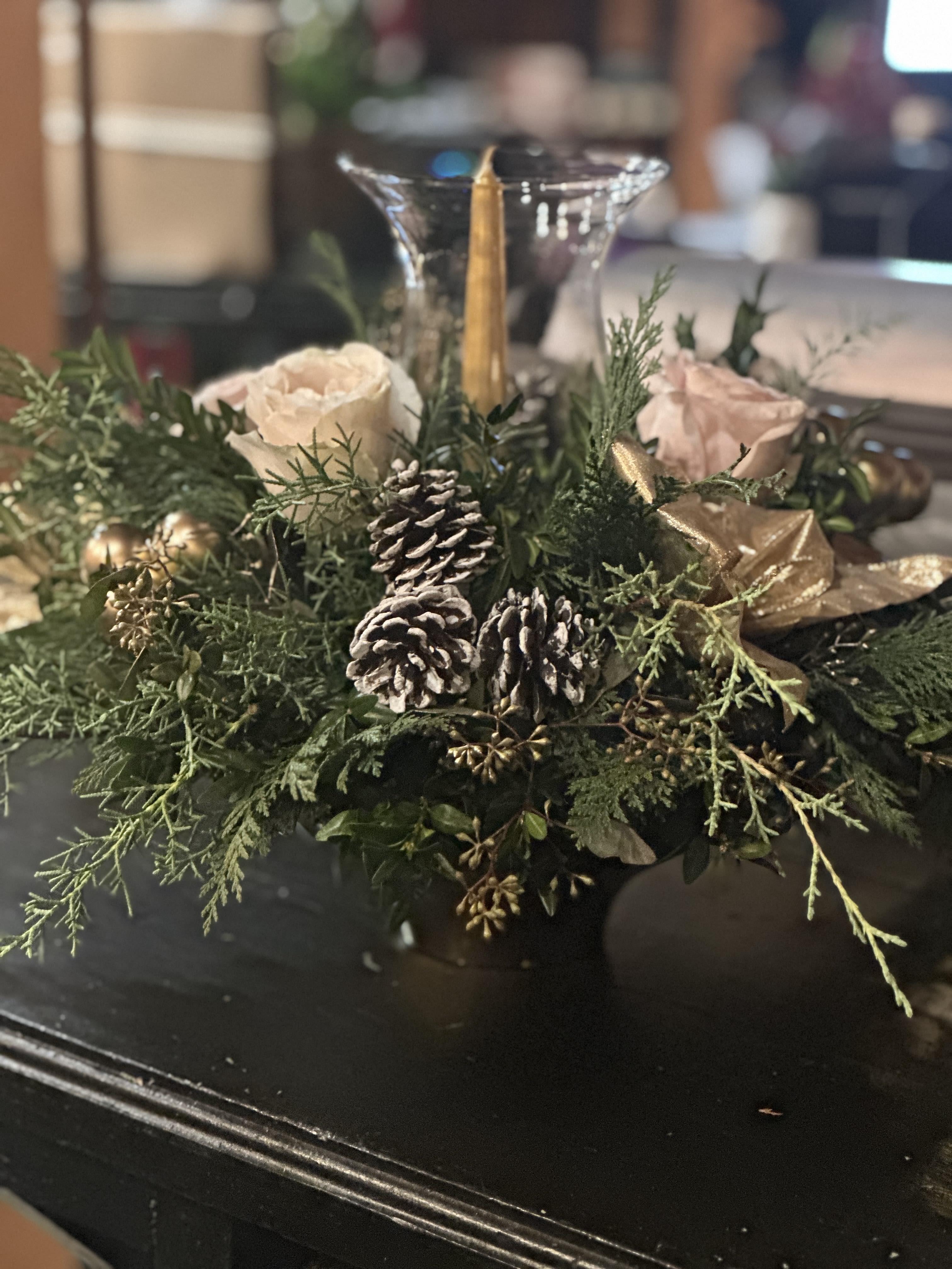 Golden Glow - Golden Glow  A warm, elegant arrangement of winter greens, soft blush roses, gilded accents, and candlelight—designed to bring a cozy, festive glow to your table all season long.