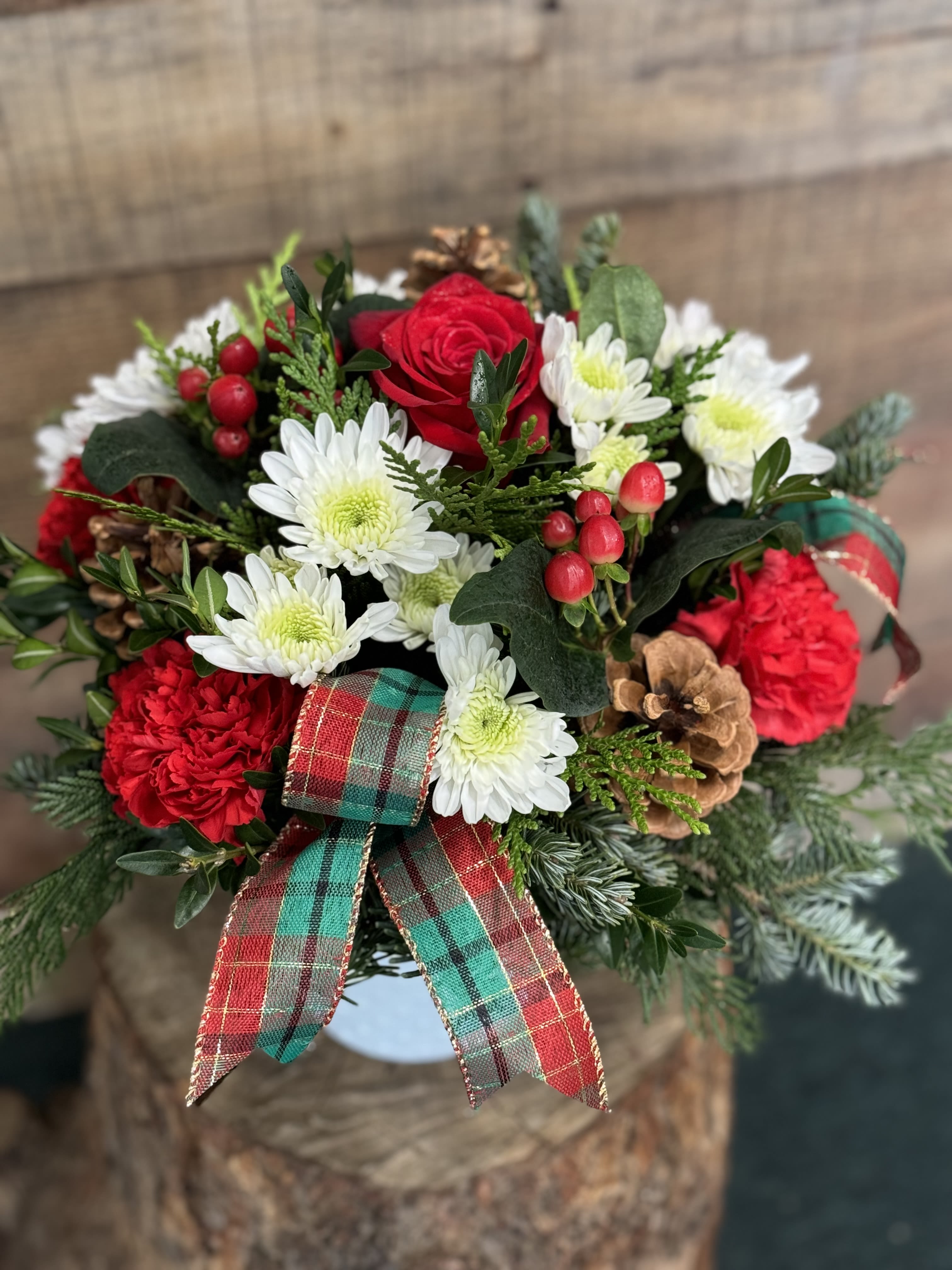 Seasons Greetings - Beautiful assortment of long lasting flowers accented with a Christmas rose, cones and fragrant evergreens.