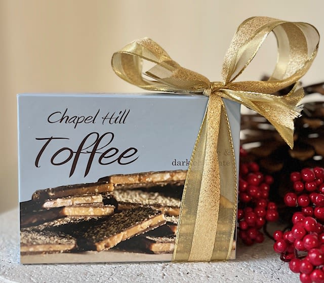 Chapel Hill Toffee 10 Oz. - Make a statement and send a box of pecan and dark chocolate toffee with your arrangement!  DELIVERY IS ONLY AVAILABLE WITH PURCHASE OF FLORAL ARRANGEMENT OR PLANT. Pickup is free.  Made local in Chapel Hill. Gluten Free. Chapel Hill Toffee (10 Ounces)