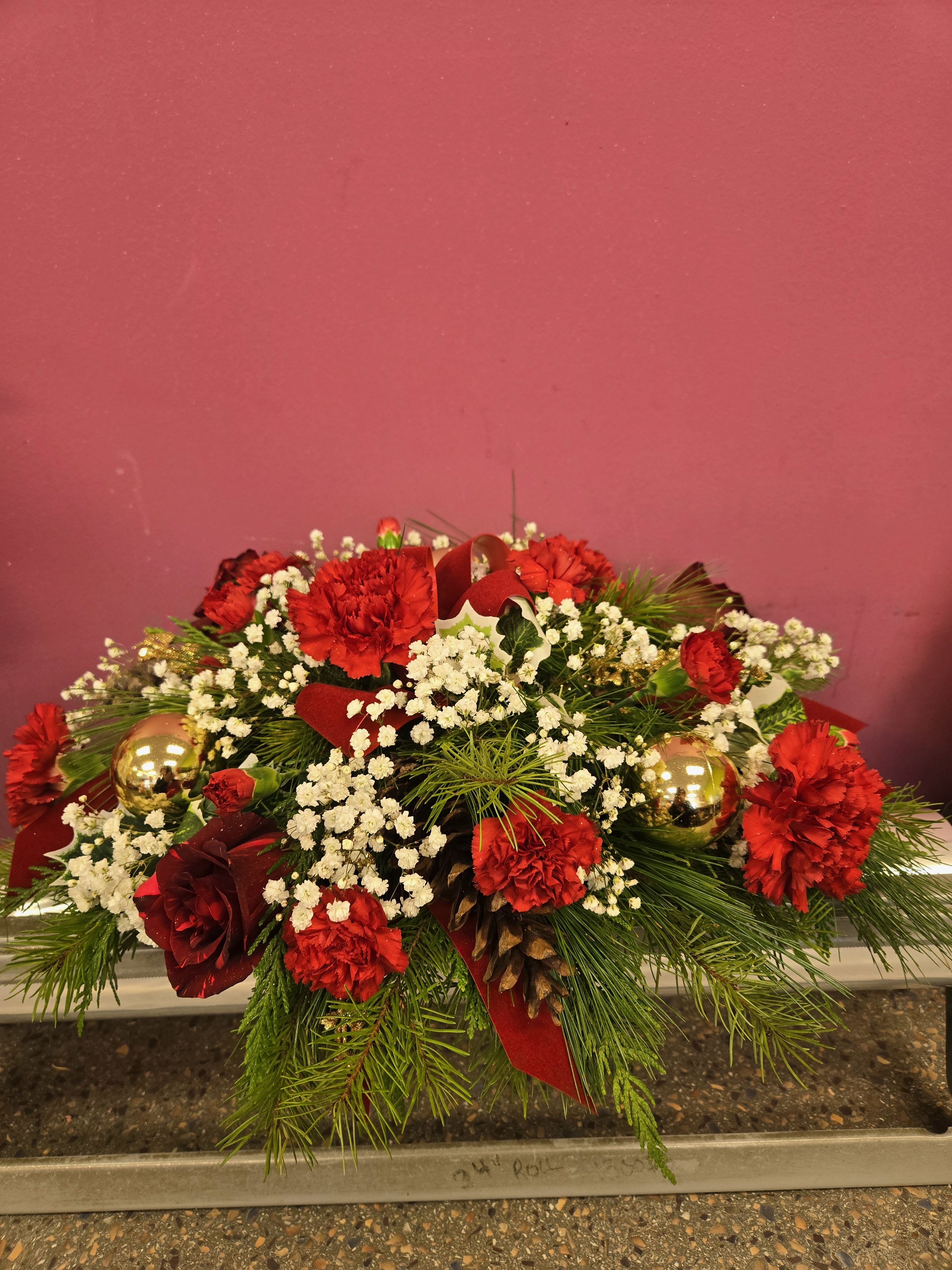 elegant holiday centerpiece - long and low the perfect accent to any holiday table, is done with red and white flowers 