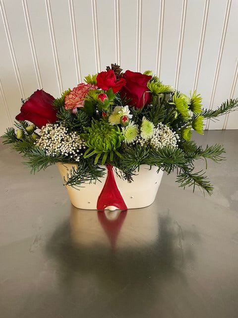 Noel - Christmas greens, reds and whites and more green to create a fun, festive arrangement in a cute gnome container. Spread the Christmas cheer with this adorable little gnome.