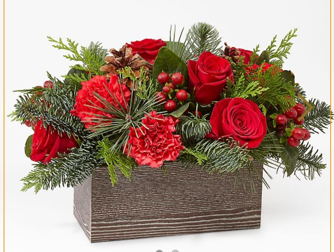 Christmas Cabin Bouquet - Inspired by the rustic charm that comes with the holiday season, elevate your décor with an array of fresh red blooms and greenery.