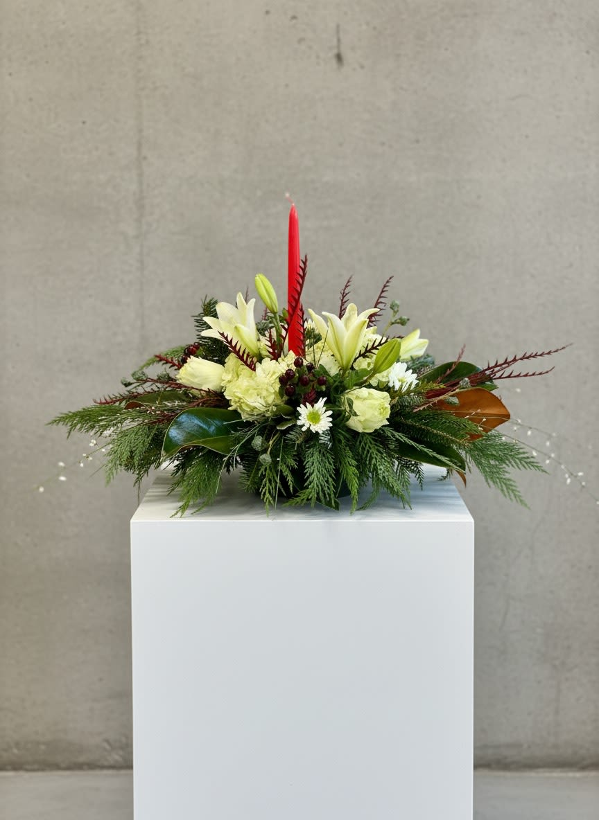 Christmas Centerpiece - Accent your table during the holidays with a beautiful centerpiece. Filled with holiday greens and seasonal flowers to bring out the Christmas Cheer!  Flowers may vary based on season and availability