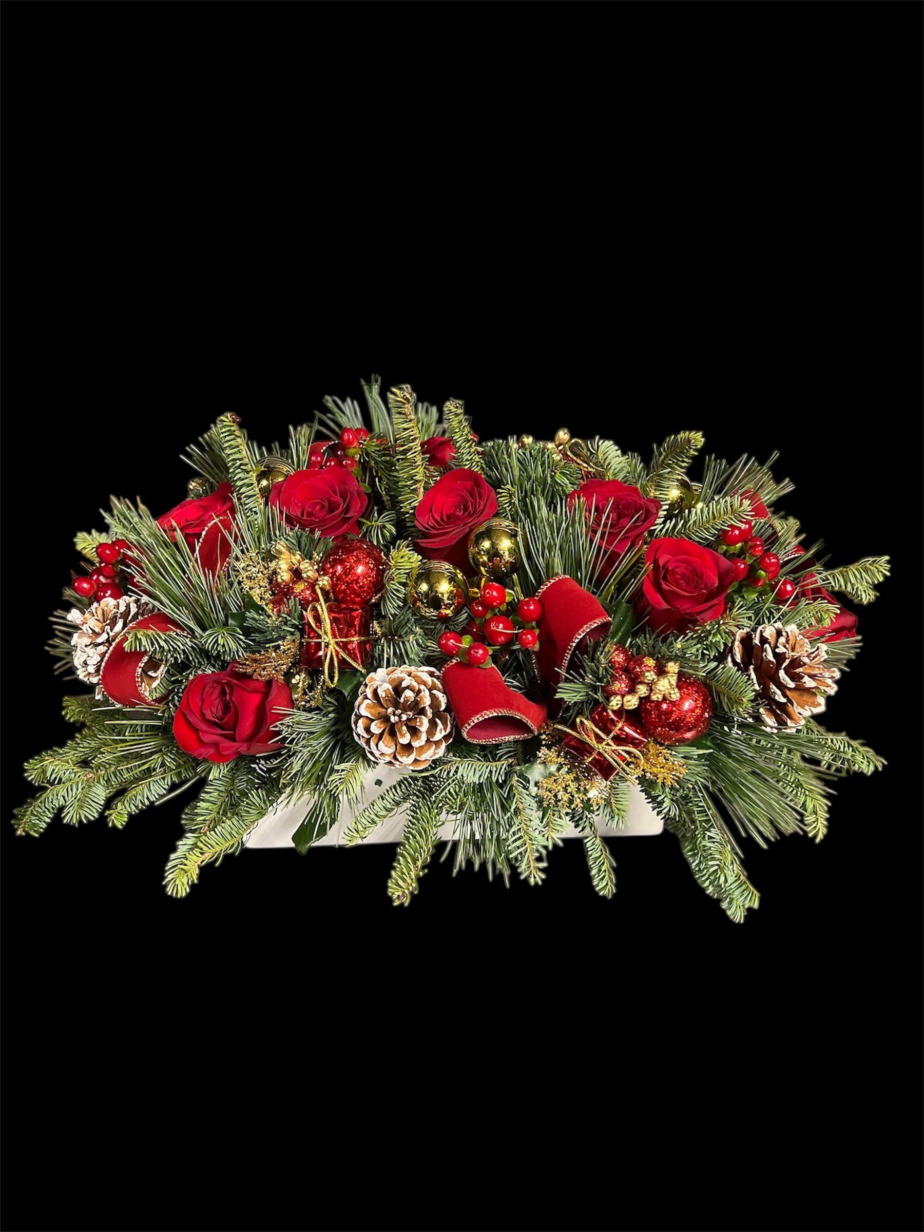 Holiday rose elegance  - Bursting with vibrant red roses and balsam, accented with festive Christmas decor for a touch of holiday charm.