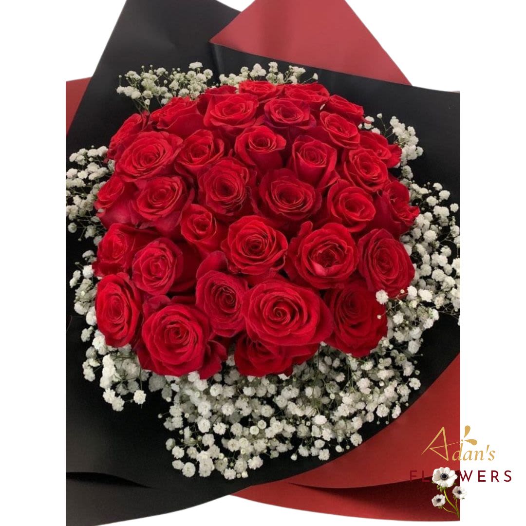 Beatiful Day - Striking bouquet of fresh red roses with delicate white rose accents, wrapped in bold black and red paper for a dramatic and elegant finish. Perfect for a powerful expression of love.