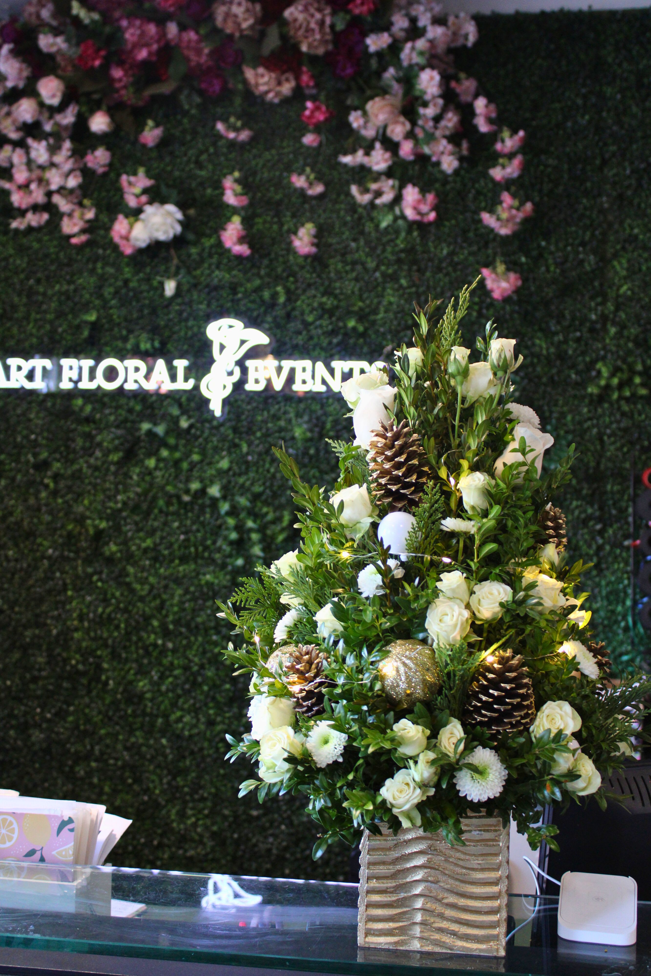 Mini Light up Christmas Tree -White and Gold - Pine Cones, White Roses, White Spray Roses, White Mums, Mini Gold Ornaments, Twinkle Lights, Square Gold Wooden Vase  