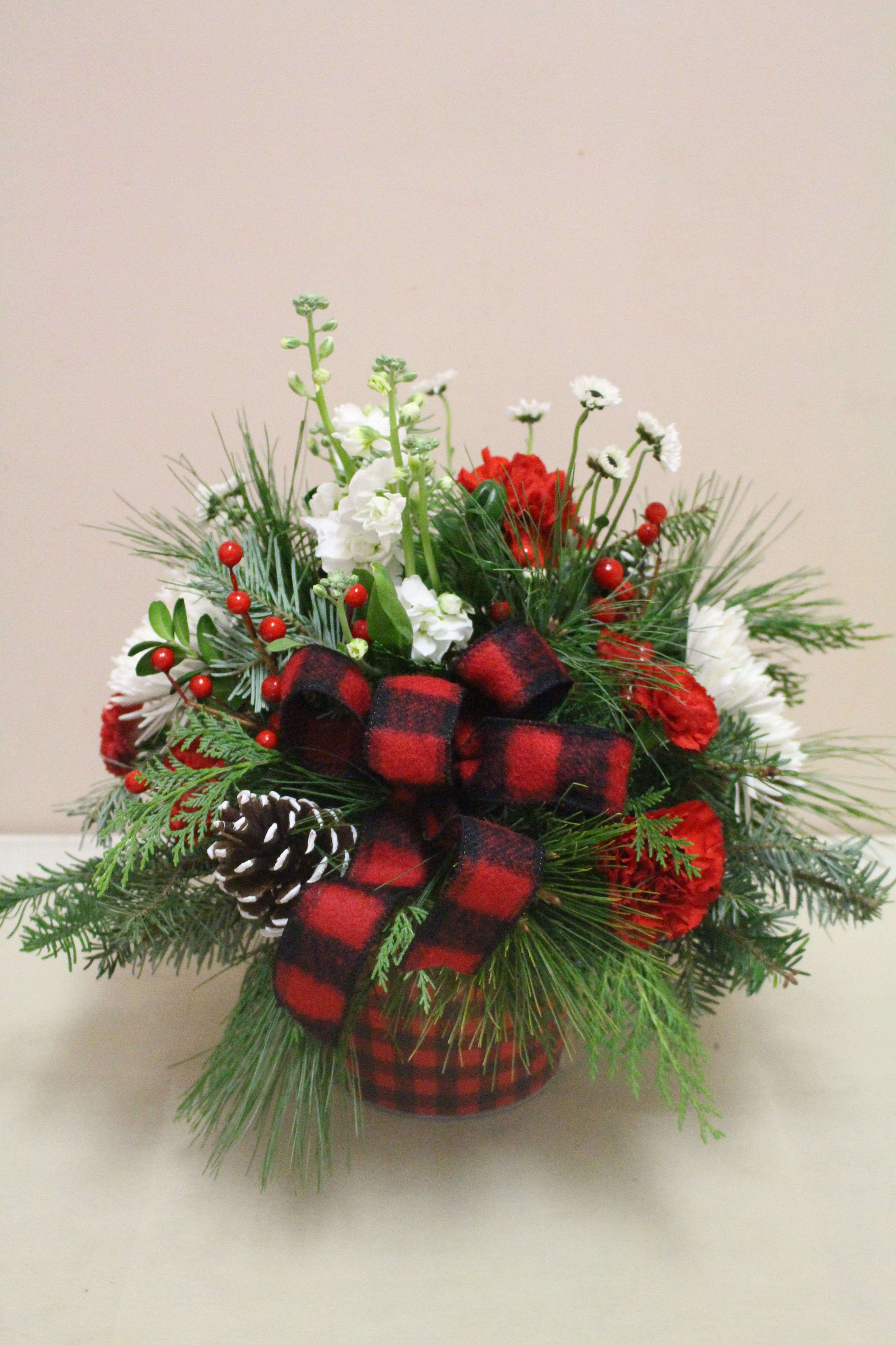 buffalo plaid - A tin buffalo plaid container has a adorable christmas arrangement filled with black and white ying yang red carnations berrys and other flowers 