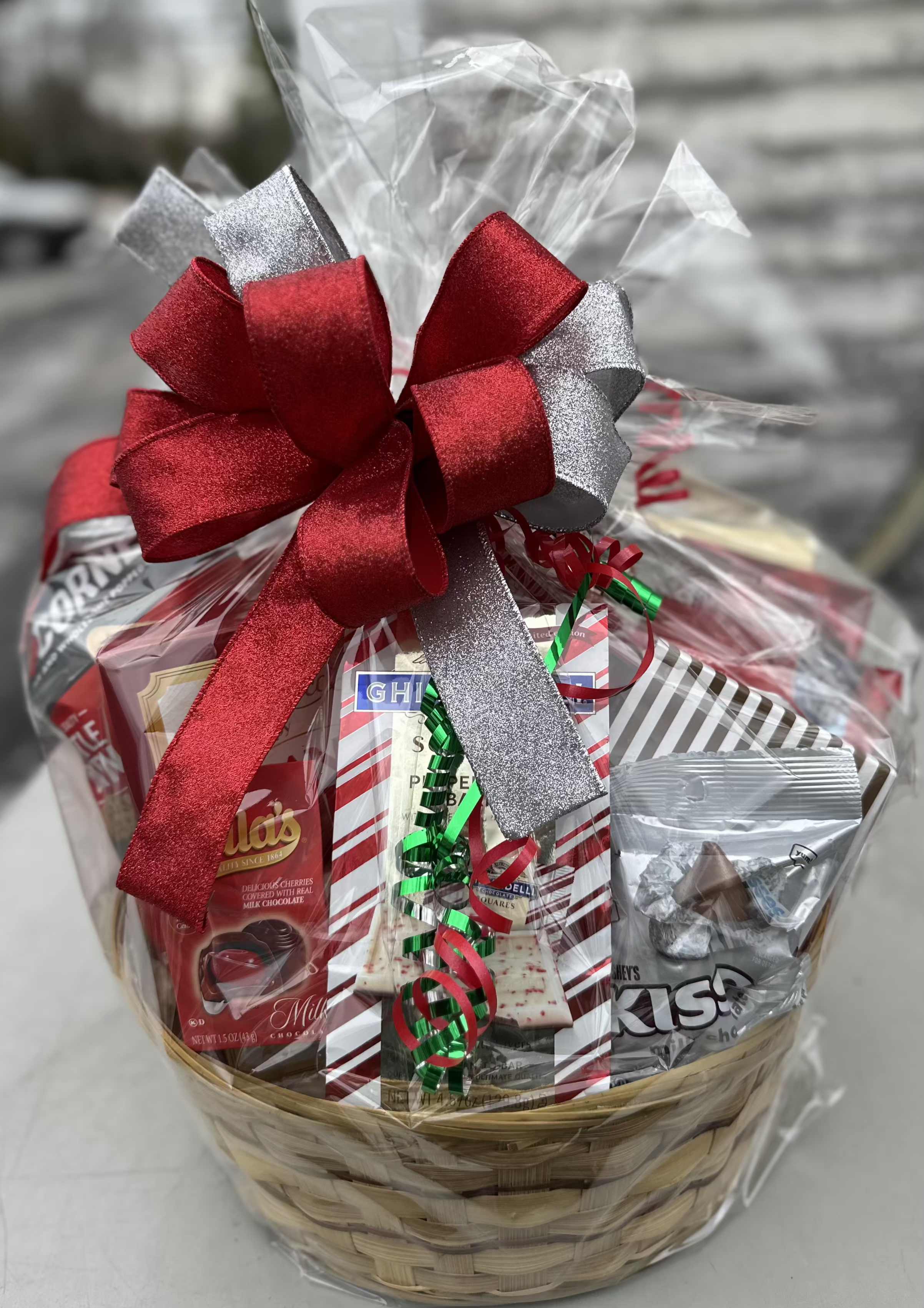Holiday Cheer Extravaganza Basket - Downtowner Abdallah top of the line assorted chocolates, European Classic Shortbread, 8oz Pretzel rods, Barton's Peanut Crisp clusters, Candy cane spoons, Peanut Brittle. Peppermint Crunch popcorn, Classic Chocolate chip cookies, Popcorners, Ghiradelli Peppermint Bark, Hershey kisses and Cello Chocolate cherries