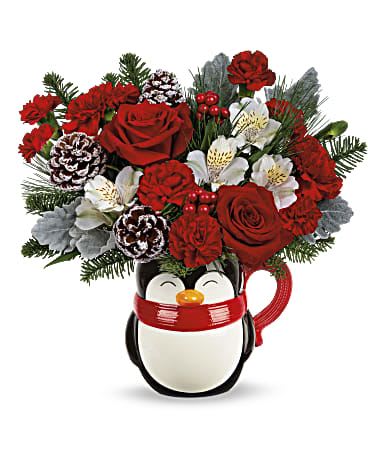 Send a Hug Penguin - This cheerful holiday arrangement features rich red roses and carnations accented with creamy white alstroemeria, festive red berries, frosted pinecones, and fragrant evergreen sprigs. Designed in an adorable penguin-shaped mug, it brings a cozy, wintry charm that’s perfect for spreading warmth, joy, and seasonal smiles.