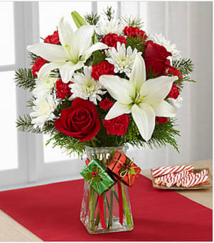 The FTD® Joyous Holiday™ Bouquet - The FTD® Joyous Holiday™ Bouquet is a seasonal sensation your special recipient will love. Rich red roses, carnations, and mini carnations are brought together with brilliant white Asiatic lilies and chrysanthemums accented with lush holiday greens to create an incredible fresh flower arrangement. Presented in a clear glass vase embellished with red ribbon to give it a festive look, this holiday flower bouquet will make an excellent Christmas gift for your favorite friends, family or co-workers. GOOD bouquet is approximately 17"H x 14"W. Your purchase includes a complimentary personalized gift message.