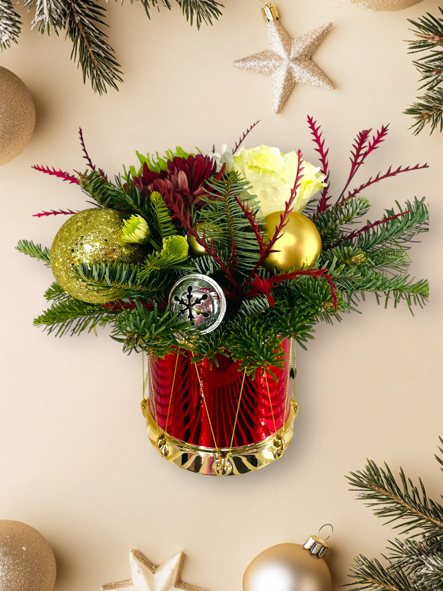 Little Drummer  - A spin on a classic Christmas tune.  This pretty drum vase is decorated with fresh Christmas greens, flowers to match along with ornaments and pinecones embellishments. Perfect as a gift or to keep for yourself this holiday season.