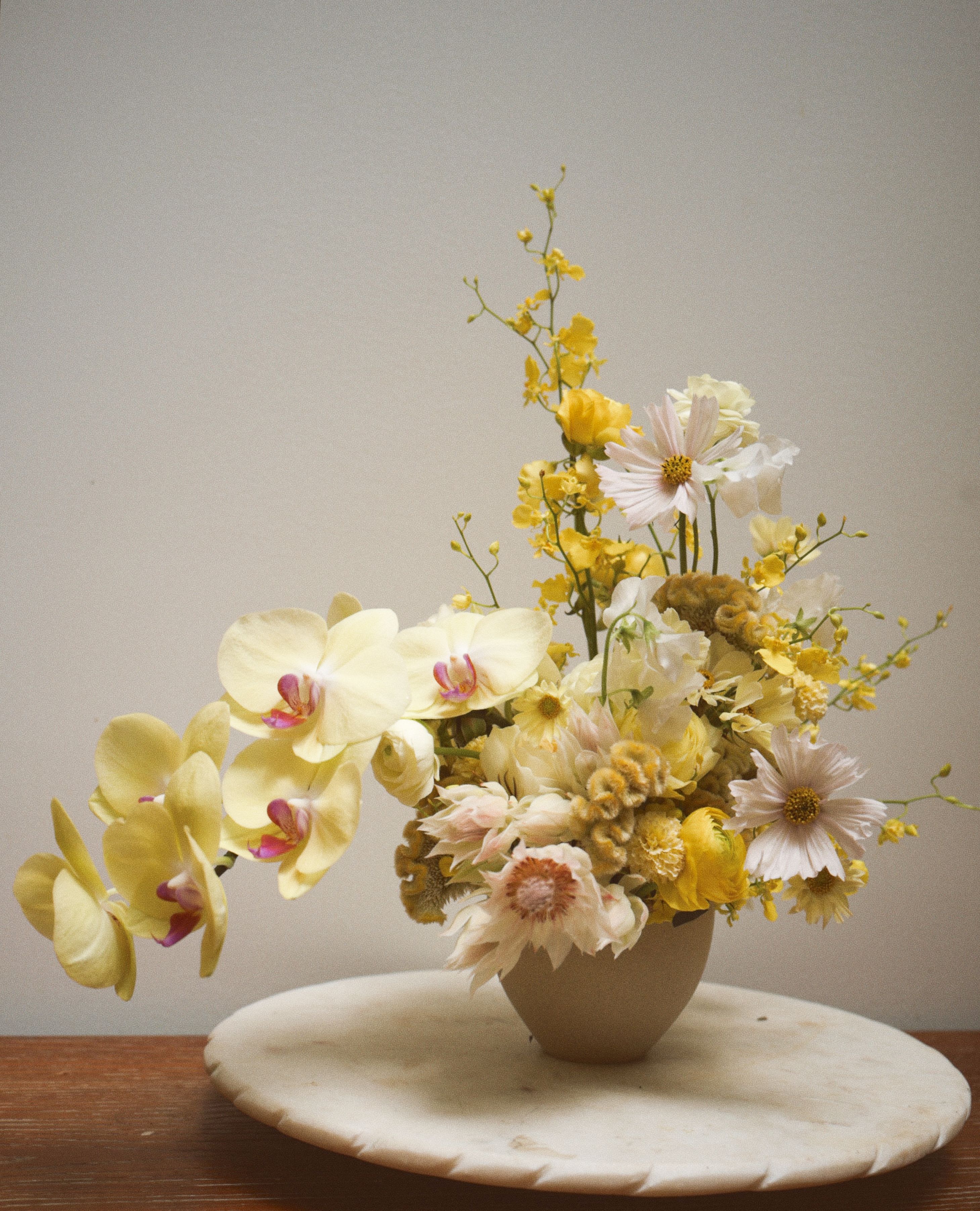 Park Avenue Sun - An all-yellow floral arrangement designed with a clean, modern aesthetic.  Featuring seasonal yellow blooms in varying textures and tones, this arrangement brings brightness and warmth while maintaining a refined, balanced look.  Flower varieties may vary based on availability, but the color palette and overall style will remain consistent.
