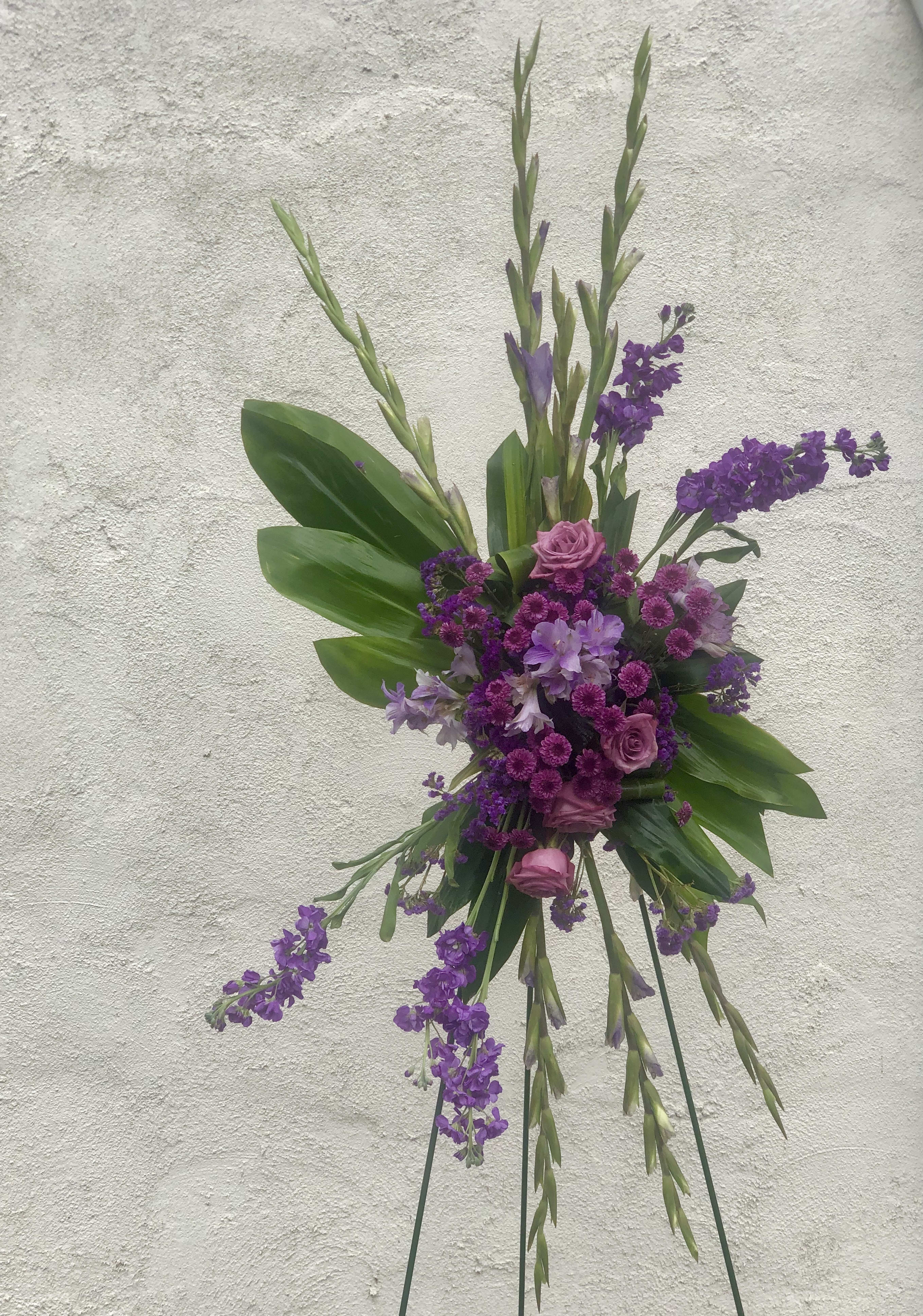 Purple Garden Standing Spray  - Send a beautiful classic purple floral sympathy standing spray to show your sympathy to a friend, co-worker or family member.