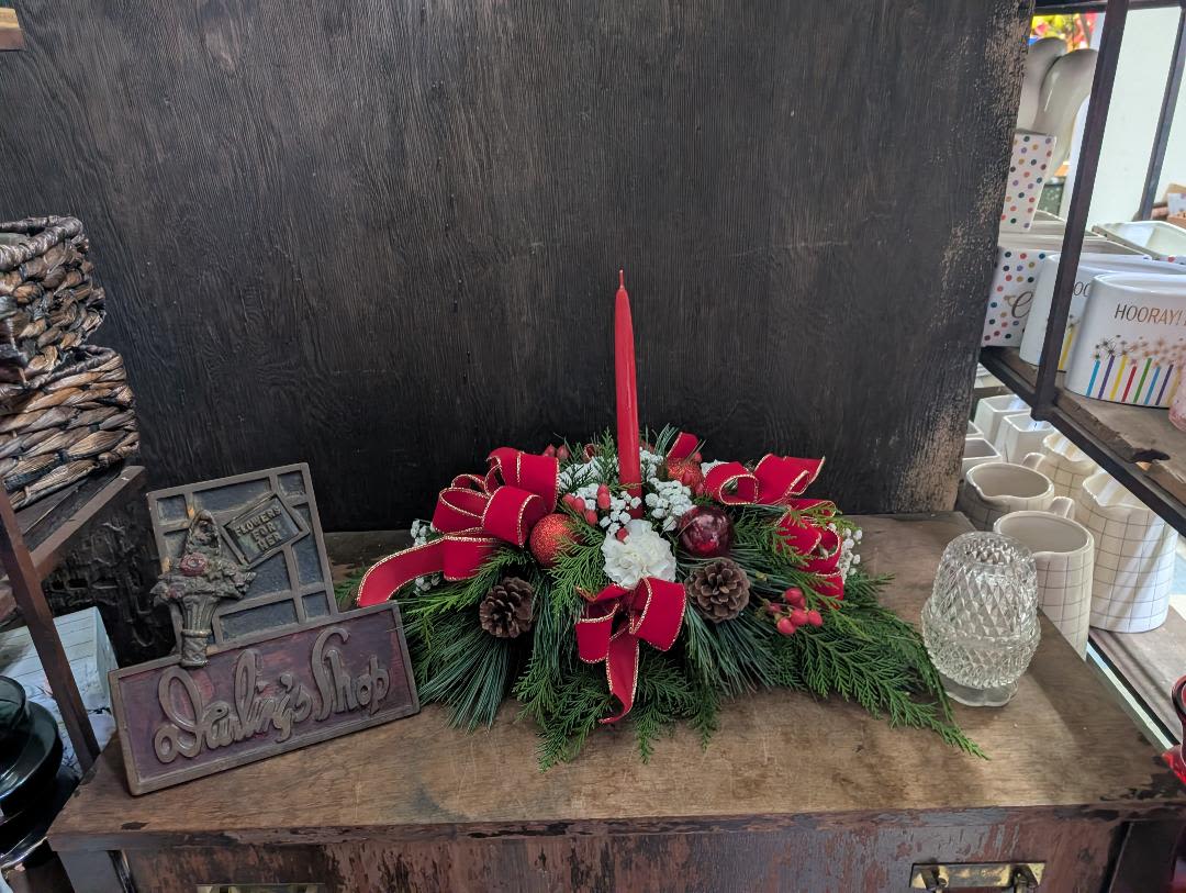 Simple Christmas Centerpiece - Candle, assorted pine, pinecones bows, carnations -- on the Deluxe and Premium  roses will be added and other flowers