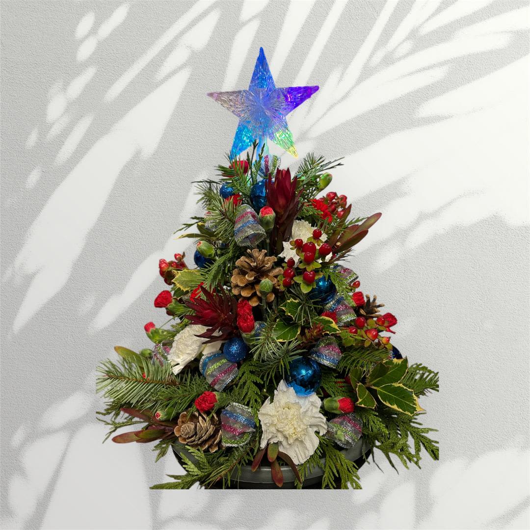 Christmas tree with light - Our photos represent the overall style and theme of each arrangement. Some vases or flowers may be one-of-a-kind and cannot be exactly replicated. Due to weather, seasonality, and market conditions, substitutions may occur. If needed, we will maintain the design’s style, theme, and color palette and only substitute items of equal or higher value.  If certain design elements are important to you, please mention them in the florist instructions at checkout or contact us to confirm availability.  Flower Care &amp; Guarantee  We guarantee flower freshness for 24 hours after they leave our shop.  Because flowers are natural, some blooms may open more fully than others.  Care Tips:  Cut flowers: Trim stems by 1 inch every 2–3 days and place in fresh water.  Arrangements in foam: Add about 1 cup of water to the foam every couple of days.  After 24 hours, proper care becomes the customer’s responsibility.  Thank you for choosing our shop!