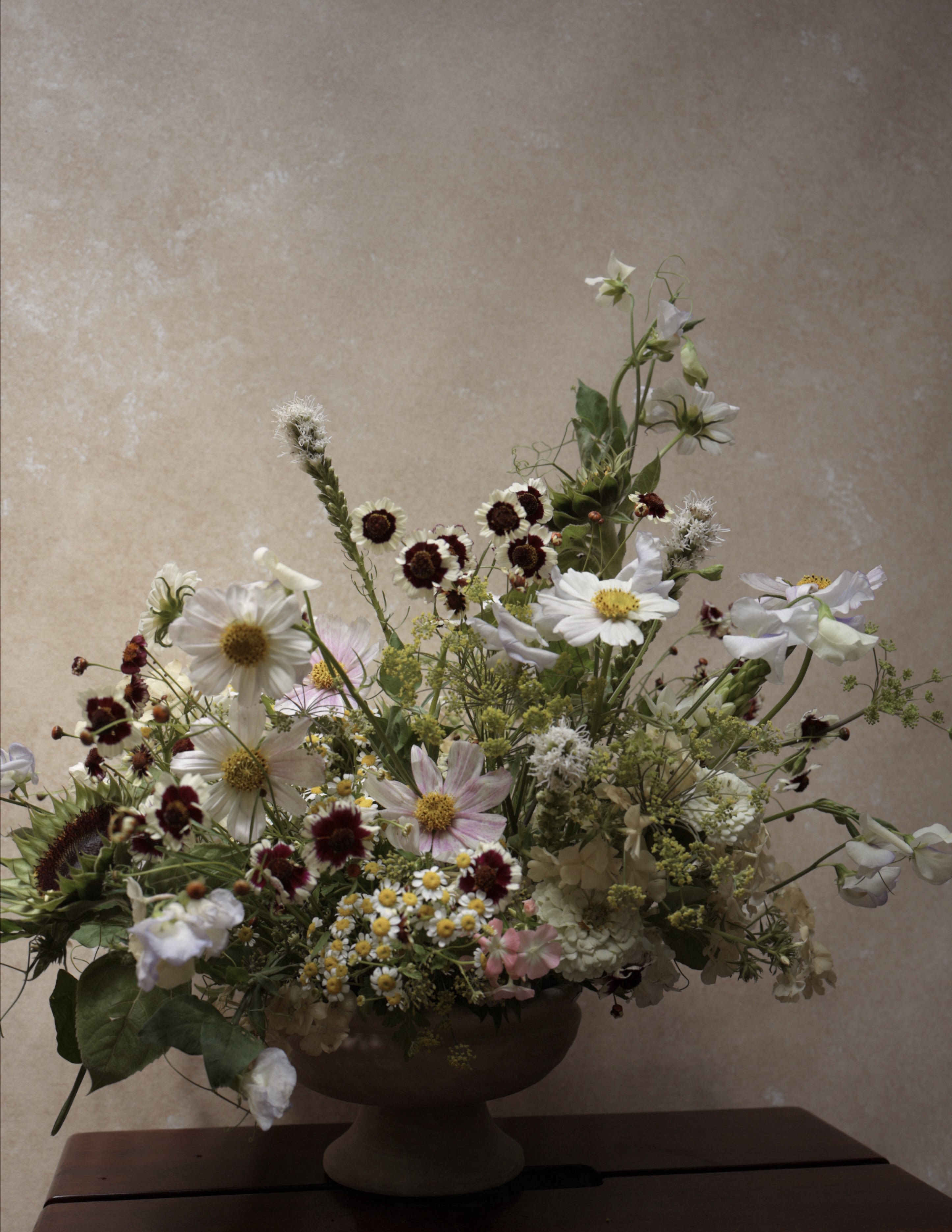 Wild at heart, NYC - wildflower-inspired arrangement designed in a ceramic vase.  Created year-round, with flowers selected based on seasonal availability and natural variety.