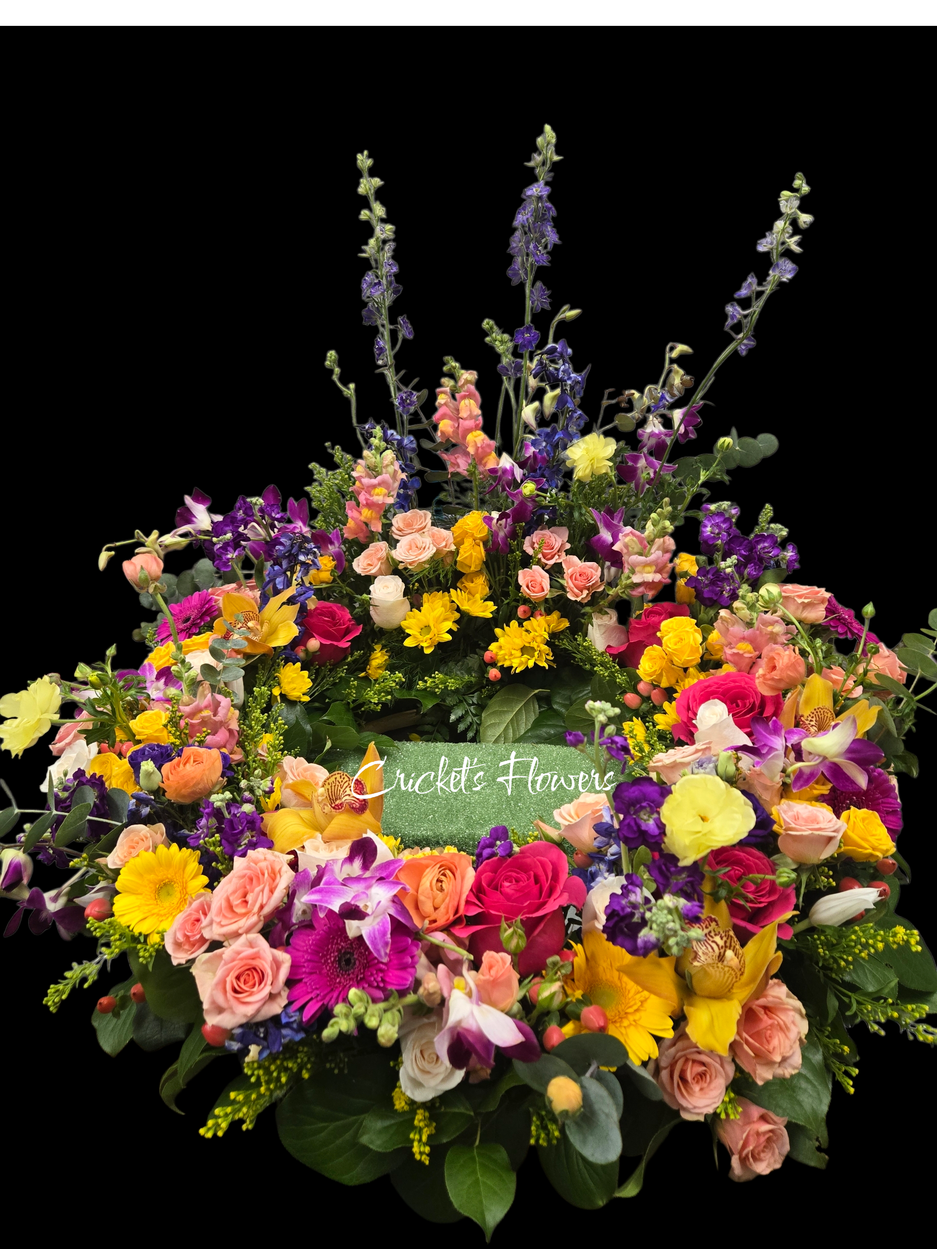 Eternal Embrace Cremation Wreath - The Eternal Embrace Cremation Wreath is a timeless symbol of love and remembrance. Designed in a classic circular form to represent everlasting life, this wreath is crafted with fresh, premium flowers and features an open center to beautifully frame a cremation urn or cherished photograph. Elegant and serene, it provides a meaningful focal point for memorial services, celebrations of life, or church settings, honoring a life remembered with grace and dignity.