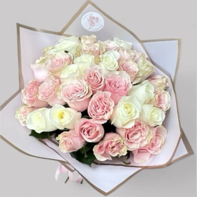 Three Dozens Of Roses #55 - This exquisite arrangement features wrapped three dozens light pink and white roses, each bloom whispers tales of romance and commitment. Whether celebrating an anniversary or declaring your love, this bouquet is a symbol of enduring affection and classic elegance. Order now for this timeless expression of love. Secure this exquisite bouquet to create lasting memories for your special someone on this romantic occasion.