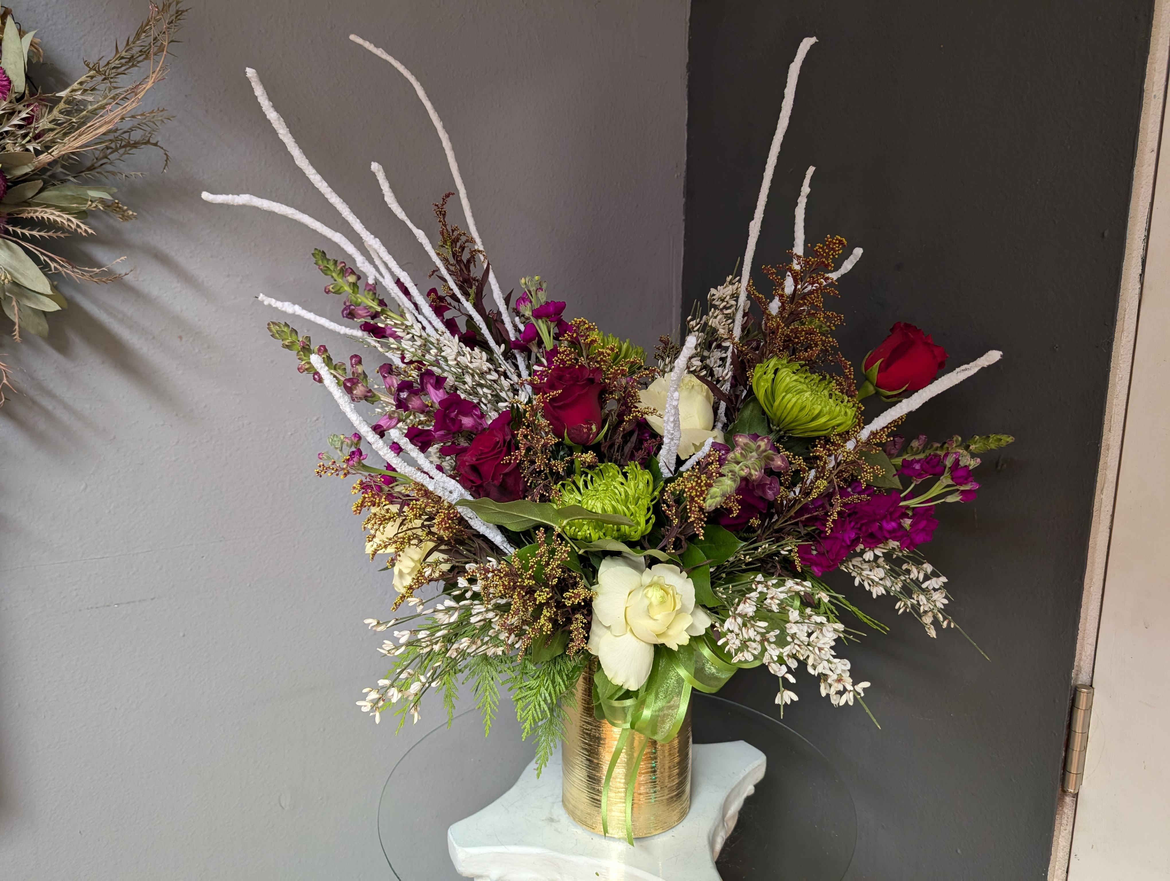 # 162 Winter Floral Arrangement - A beautifully selected bunch of the freshest flowers in a vase uniquely arranged by hand.  Comes with candies and Halloween decorations! 