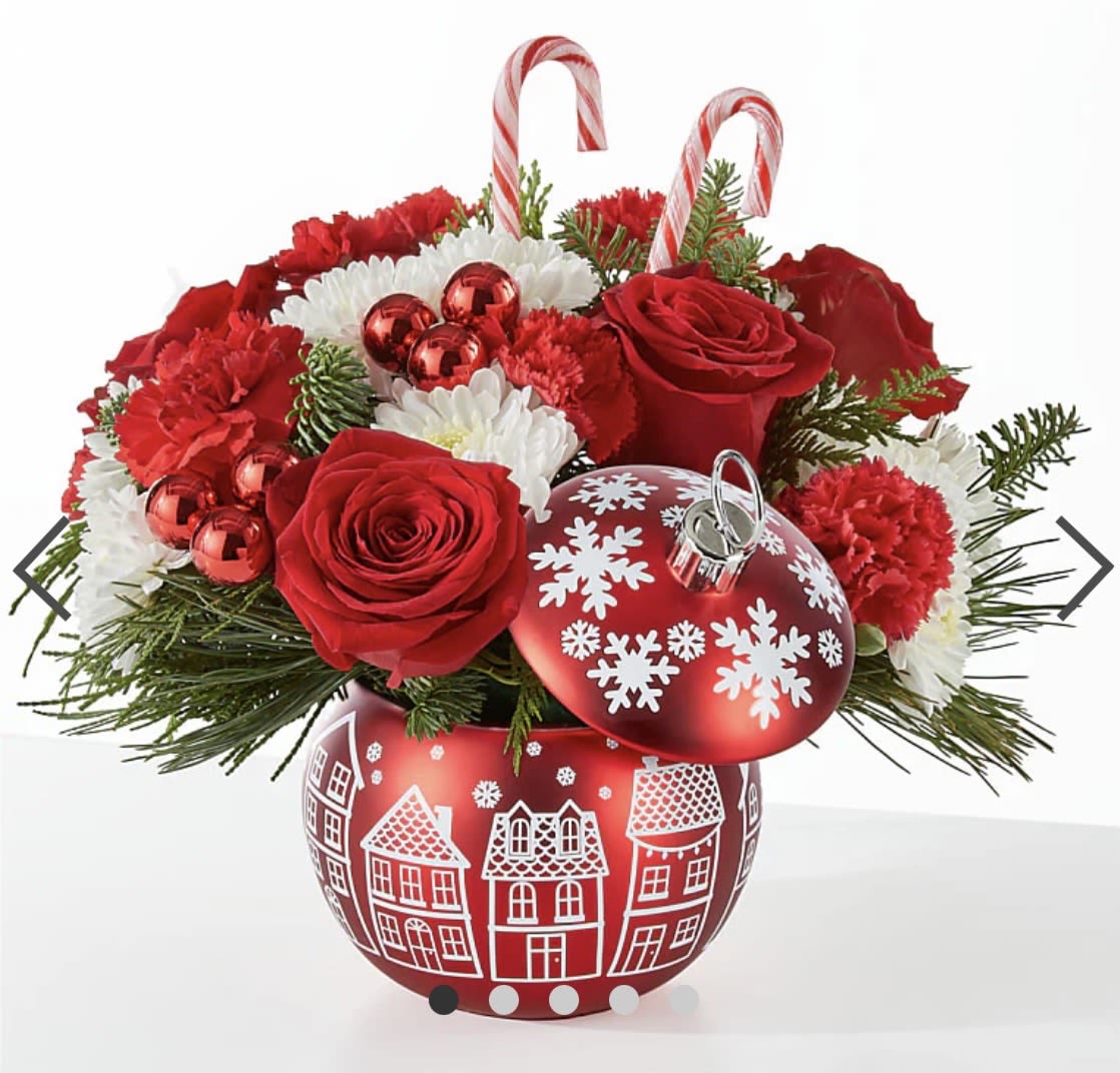 Cheer in the Air Ornament by Charlene - CHEER IN THE AIR ORNAMENT  An ornament full of blooms, perfect for any occasion this season. DETAILS  The Deluxe Bouquet is approximately 12"H x 13"W. Designed by florists, ready to display. For long–lasting blooms, add water daily. Pet Safety Precautions: This bouquet or plant may include flowers and foliage that are known to be toxic to pets. To keep them safe, be sure to keep this arrangement out of your pet's reach. BLOOM DETAILS  Carnation Rose Christmas Greens